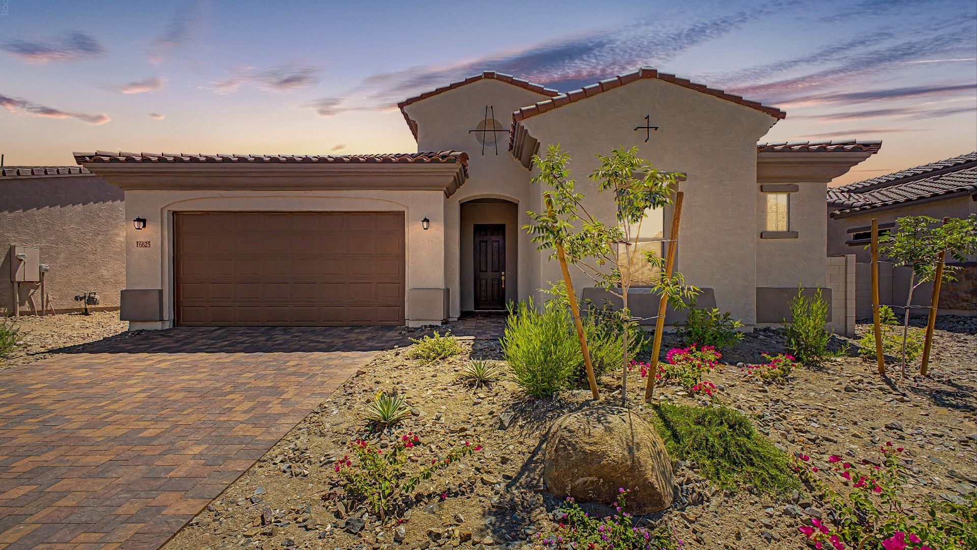 Dusk exterior of move-in ready new home by DRB Homes at Hacienda at Estrella, 16825 W. Ardmore Road, Goodyear, Arizona 85338