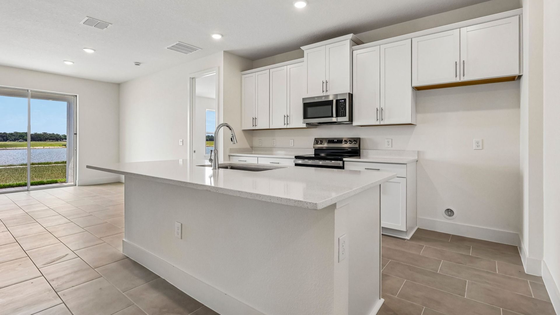Longleaf Floor Plan Kitchen and Island with overhang for seating by DRB Homes in Trailside New Homes in Mount Dora Fl