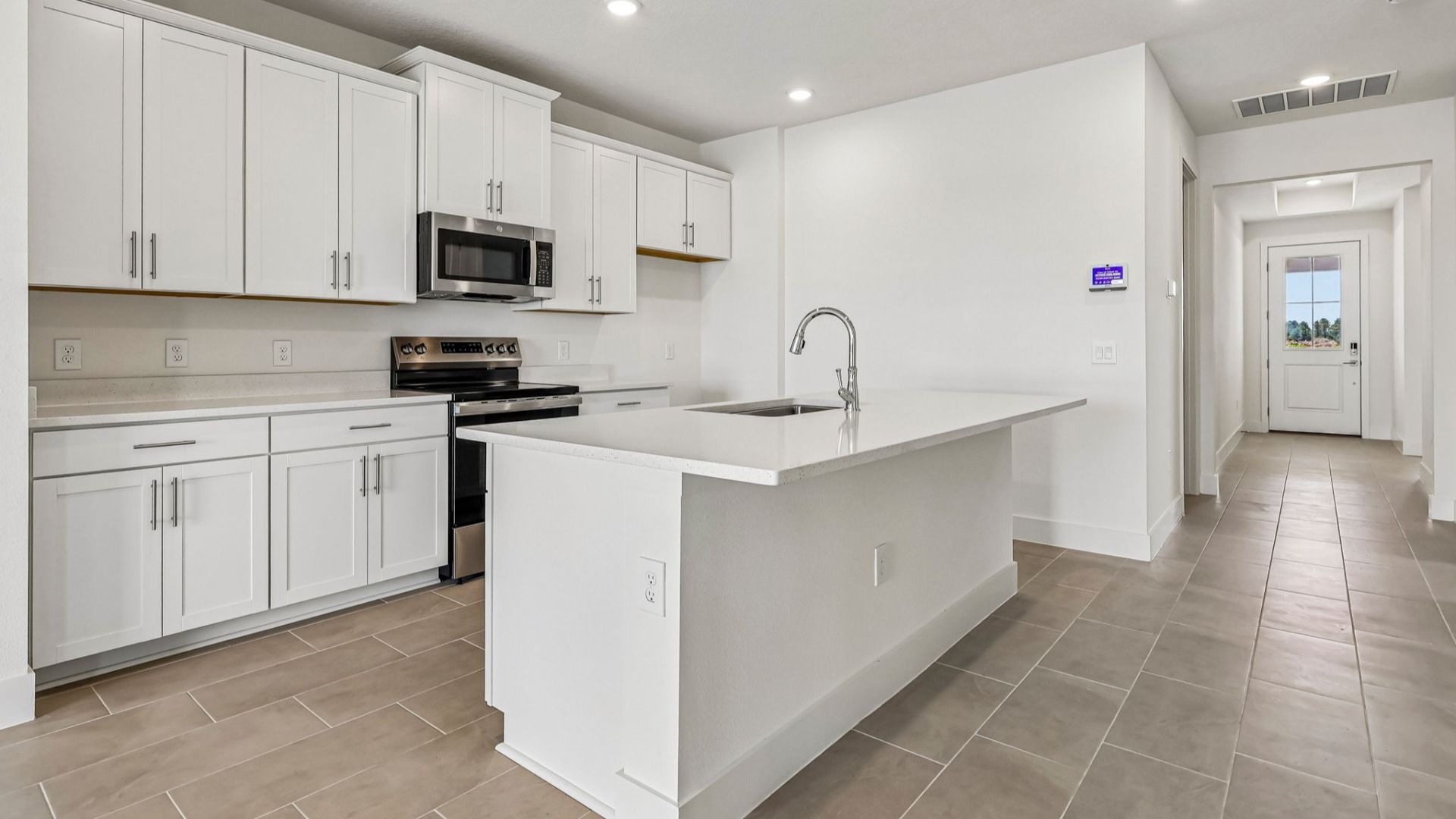 Longleaf Floor Plan Kitchen and Island with overhang for seating by DRB Homes in Trailside New Homes in Mount Dora Fl