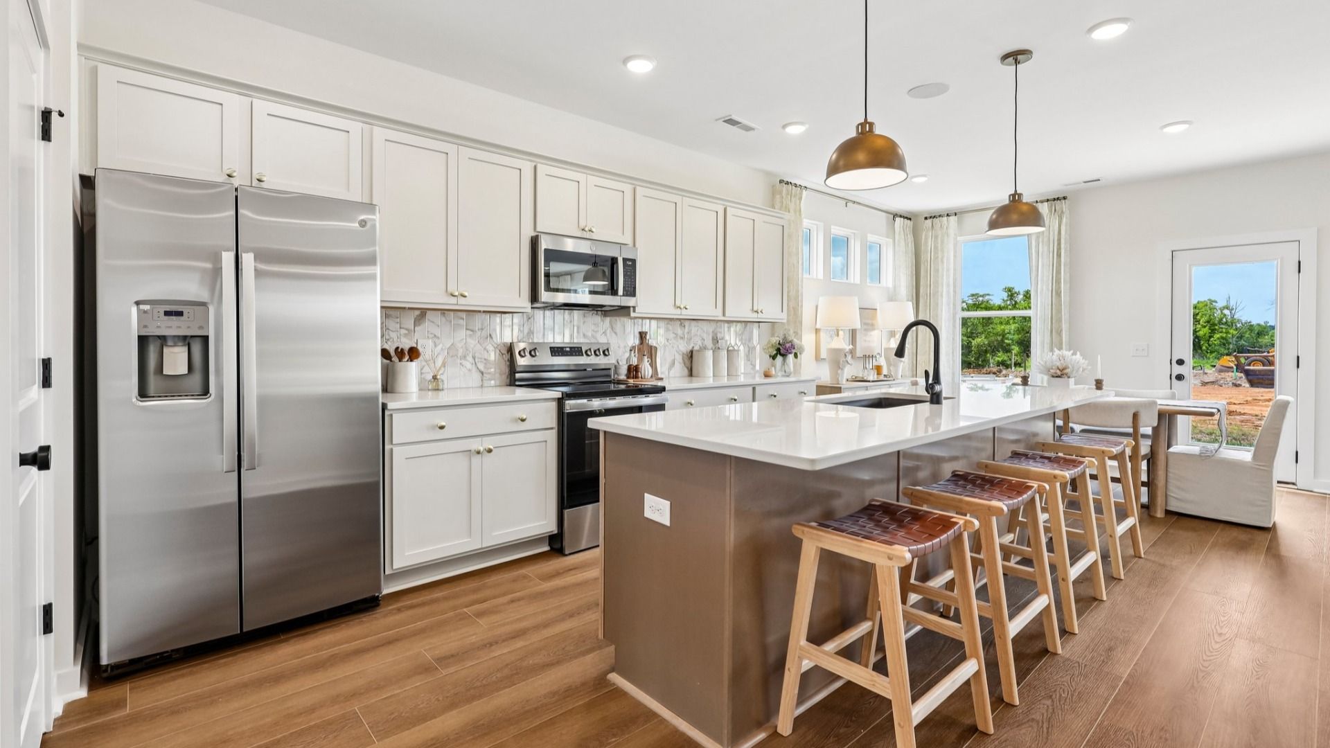 Kitchen with tile backsplash, pendant lighting, and quartz countertops