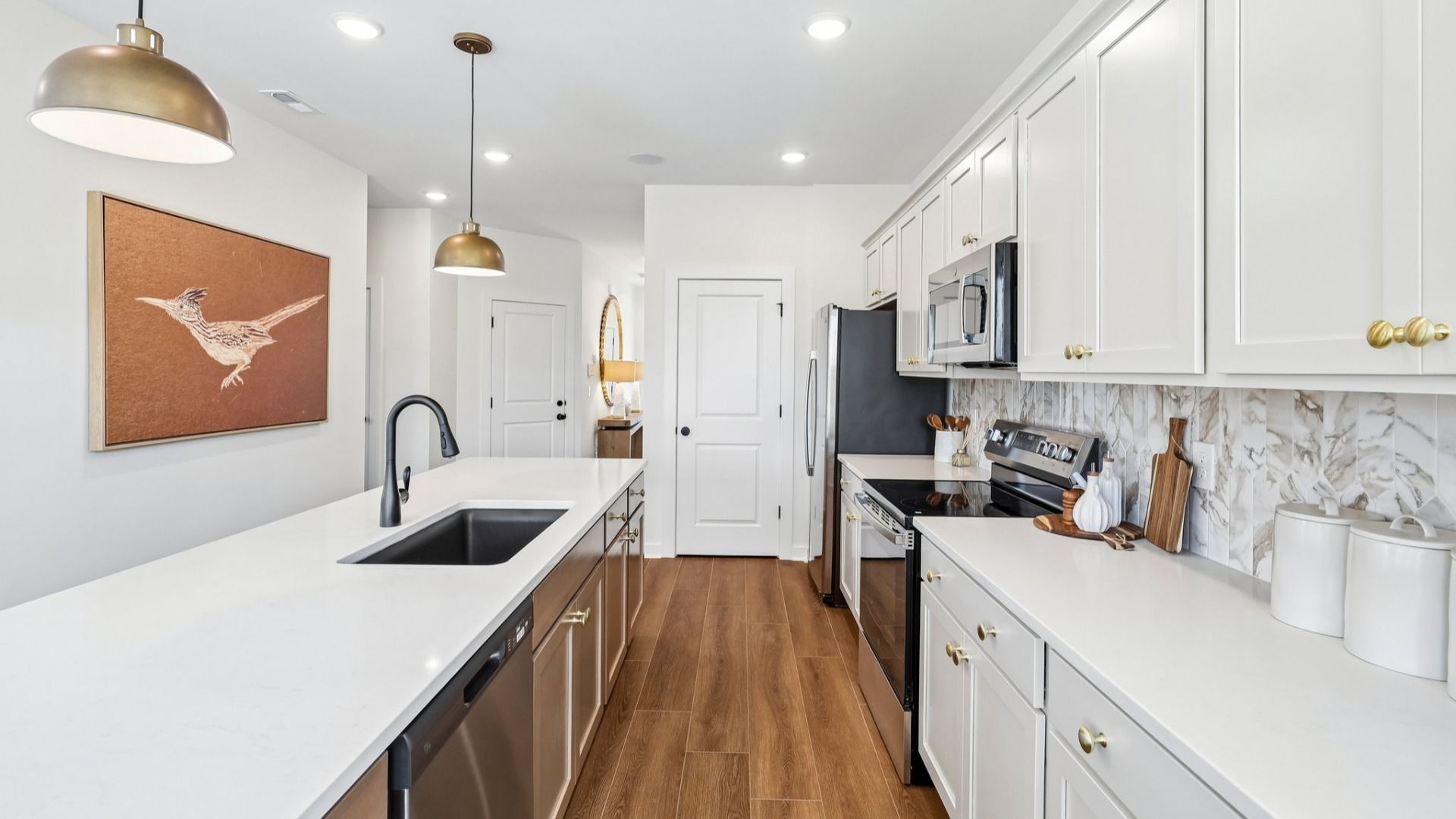 Kitchen with tile backsplash, pendant lighting, and quartz countertops