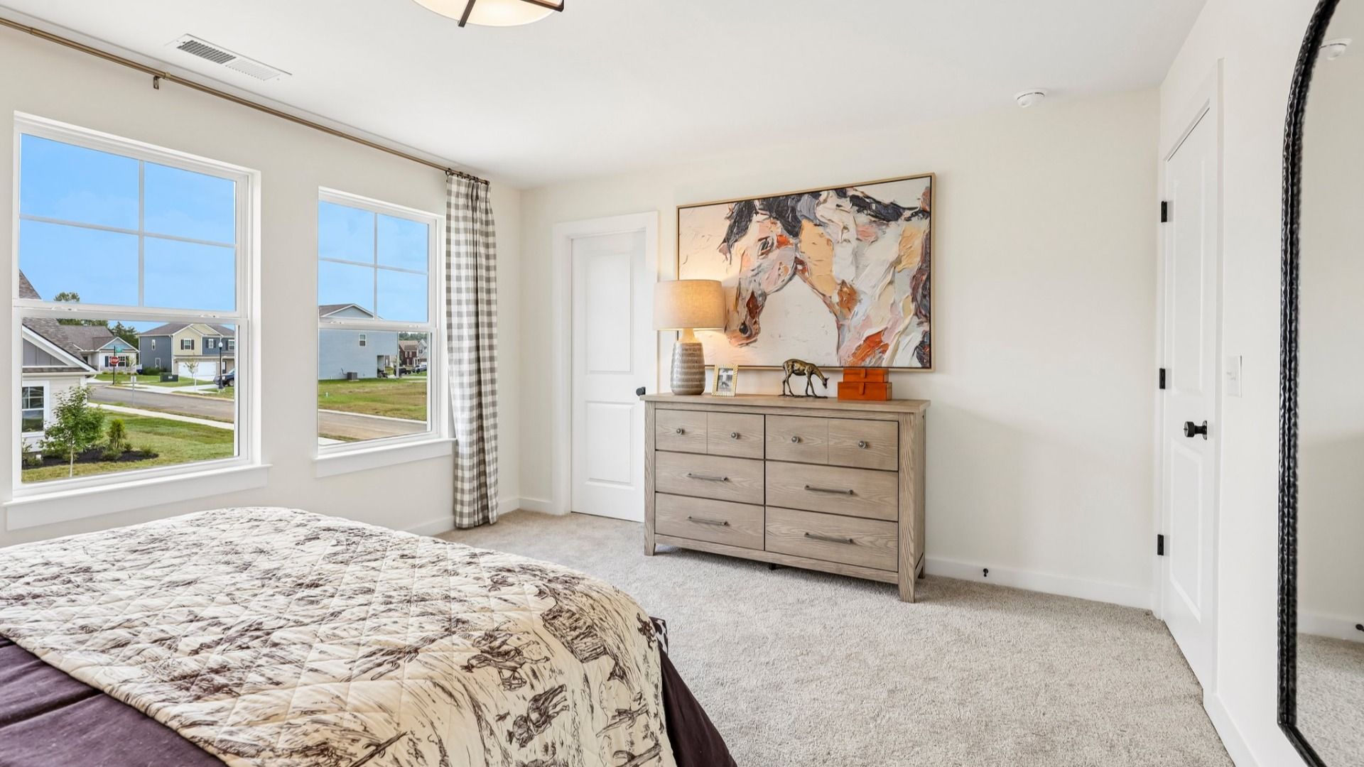 Secondary bedroom with carpet, closet, and window