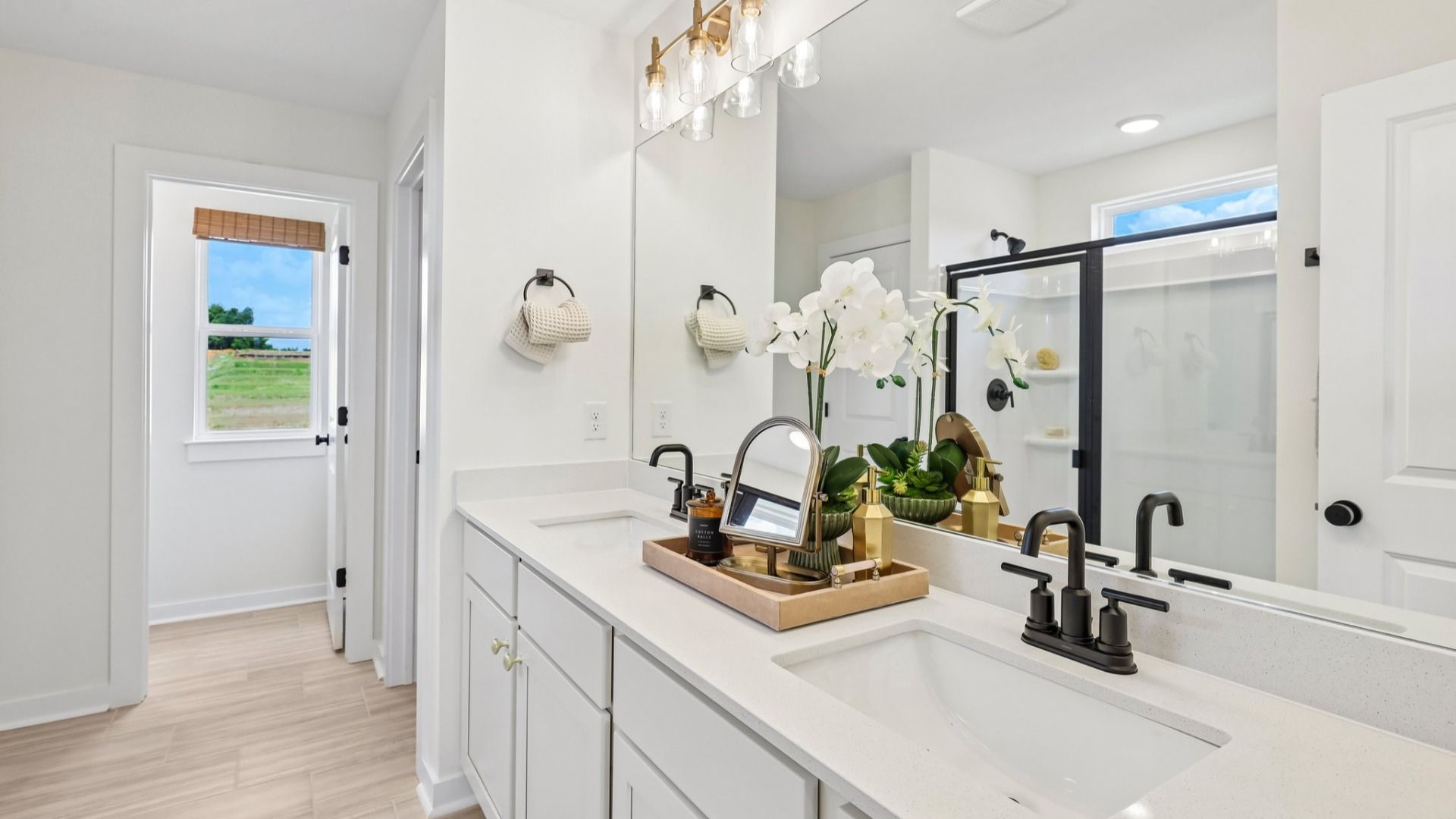 Primary bathroom with dual vanity and window