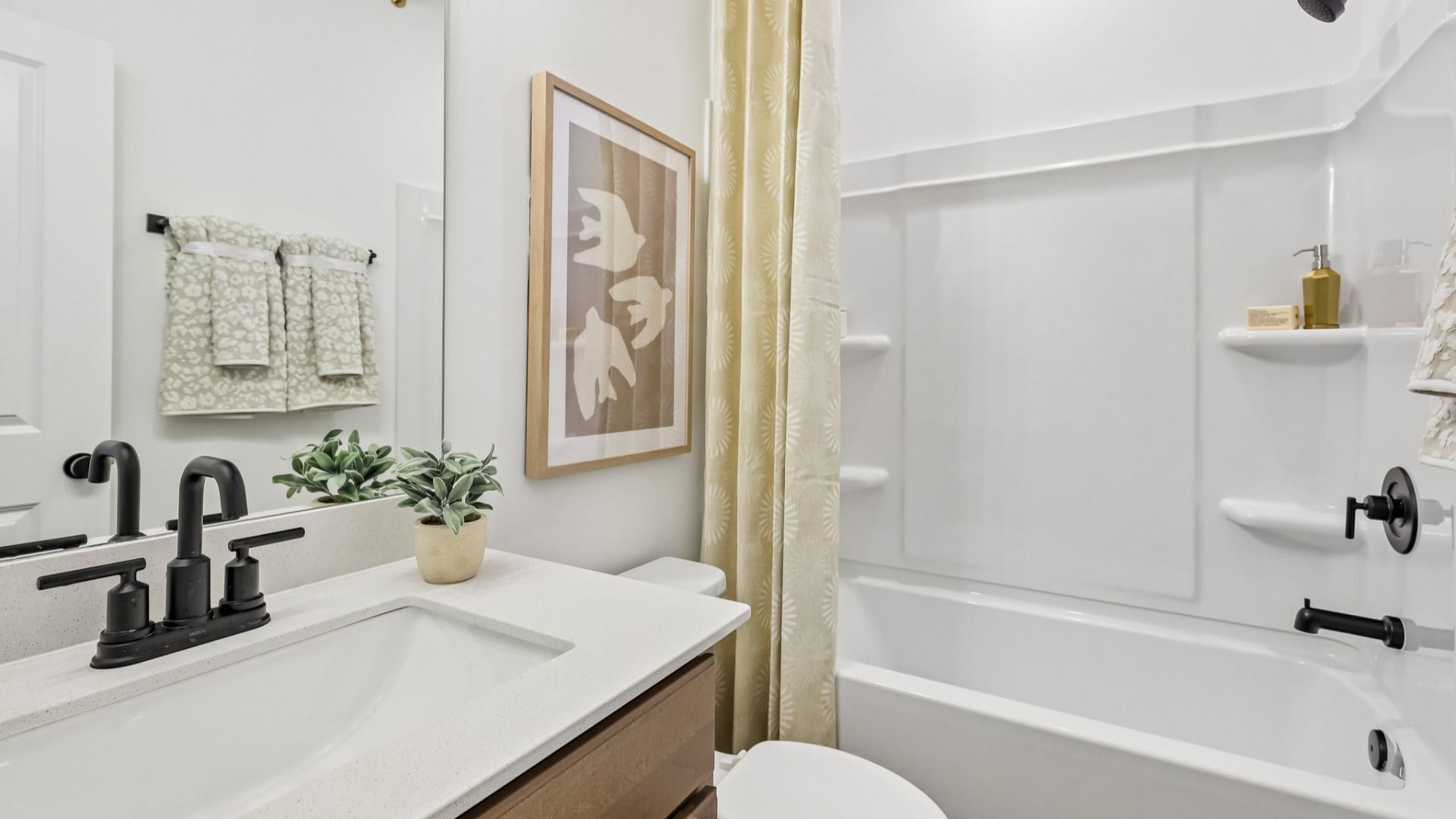 Bathroom with single vanity, toilet, and shower