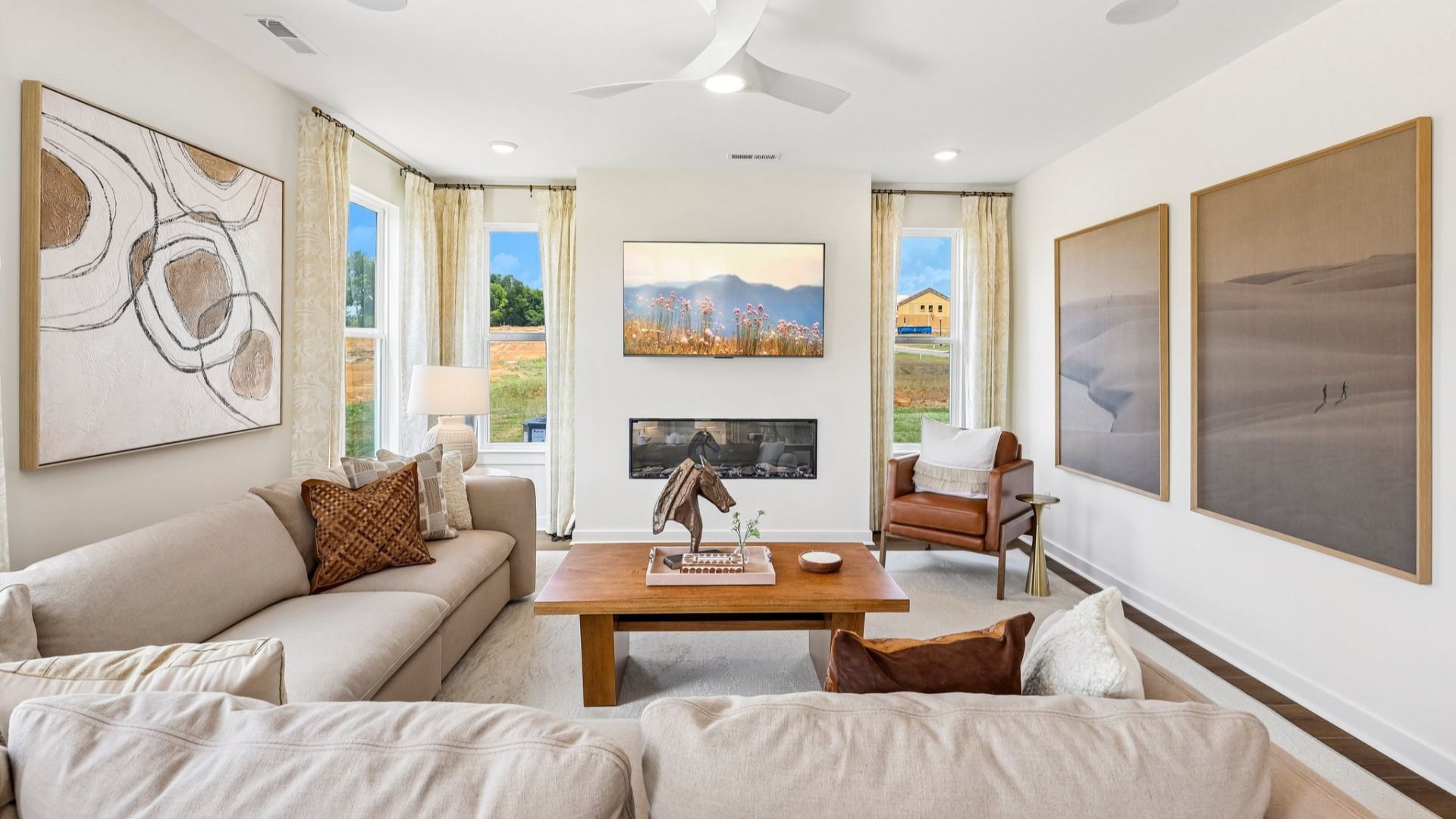 Gathering room with ceiling fan, windows, and fireplace