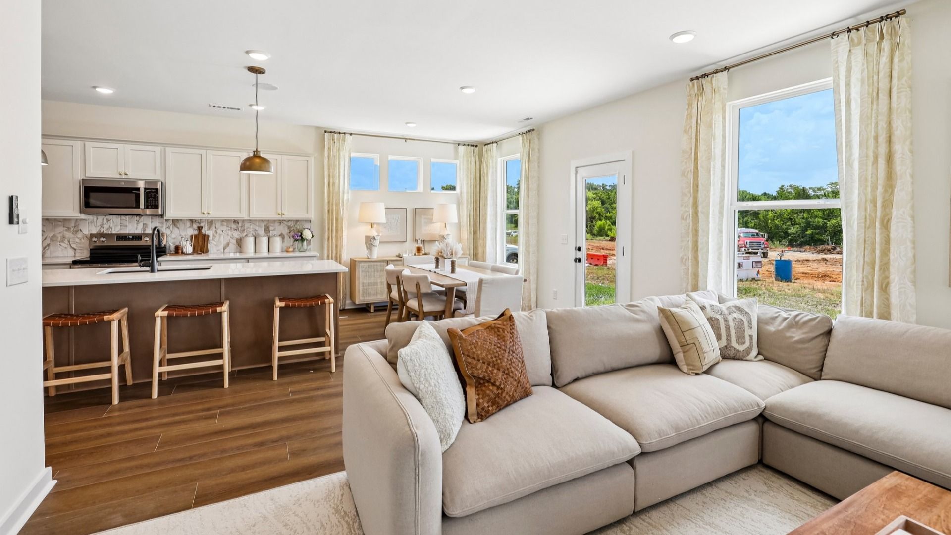 Gathering room with access to kitchen and dining area