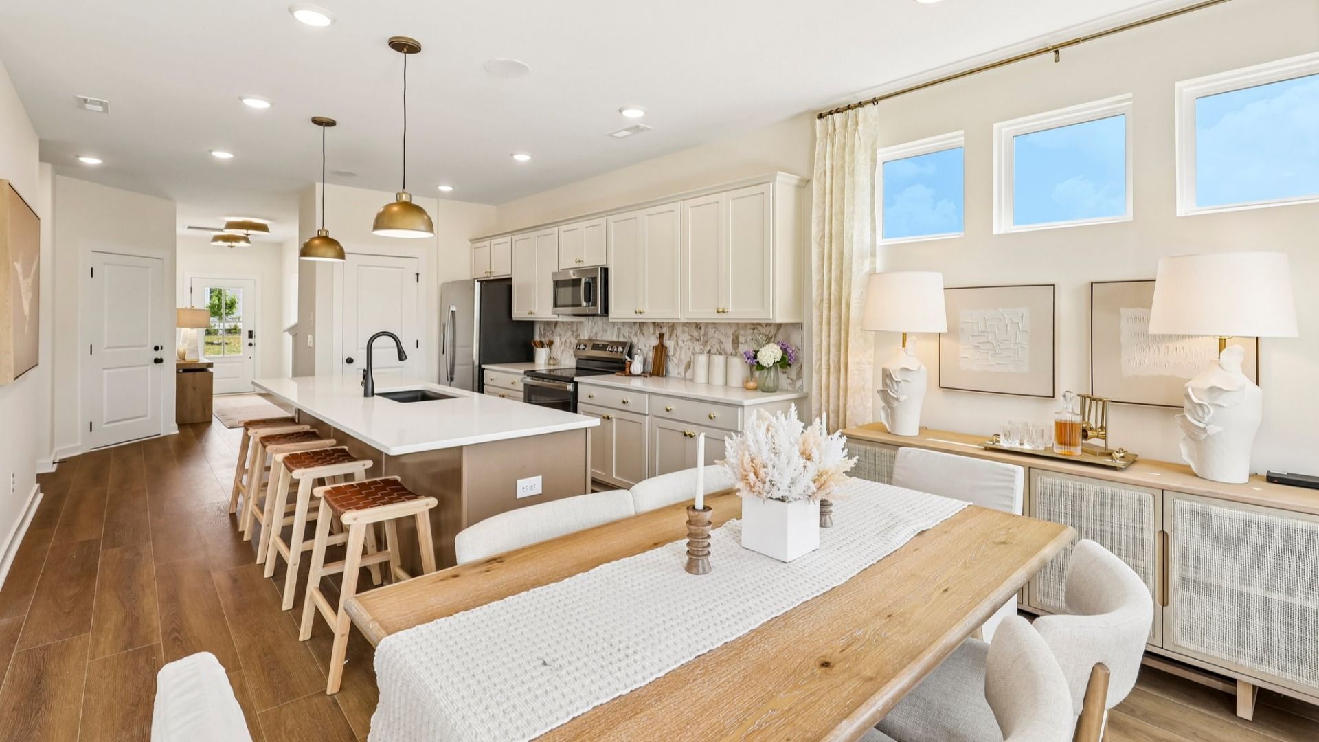 Kitchen with tile backsplash, pendant lighting, and quartz countertops