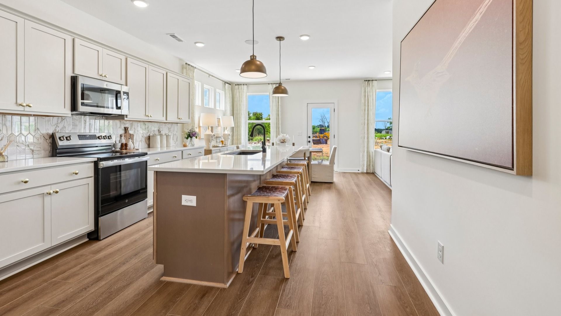 Kitchen with tile backsplash, pendant lighting, and quartz countertops
