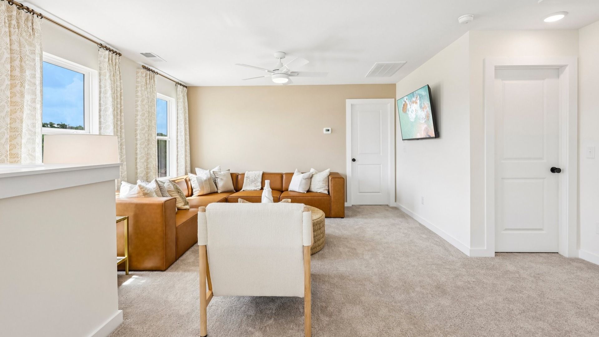 Loft area with carpet and natural lighting from windows