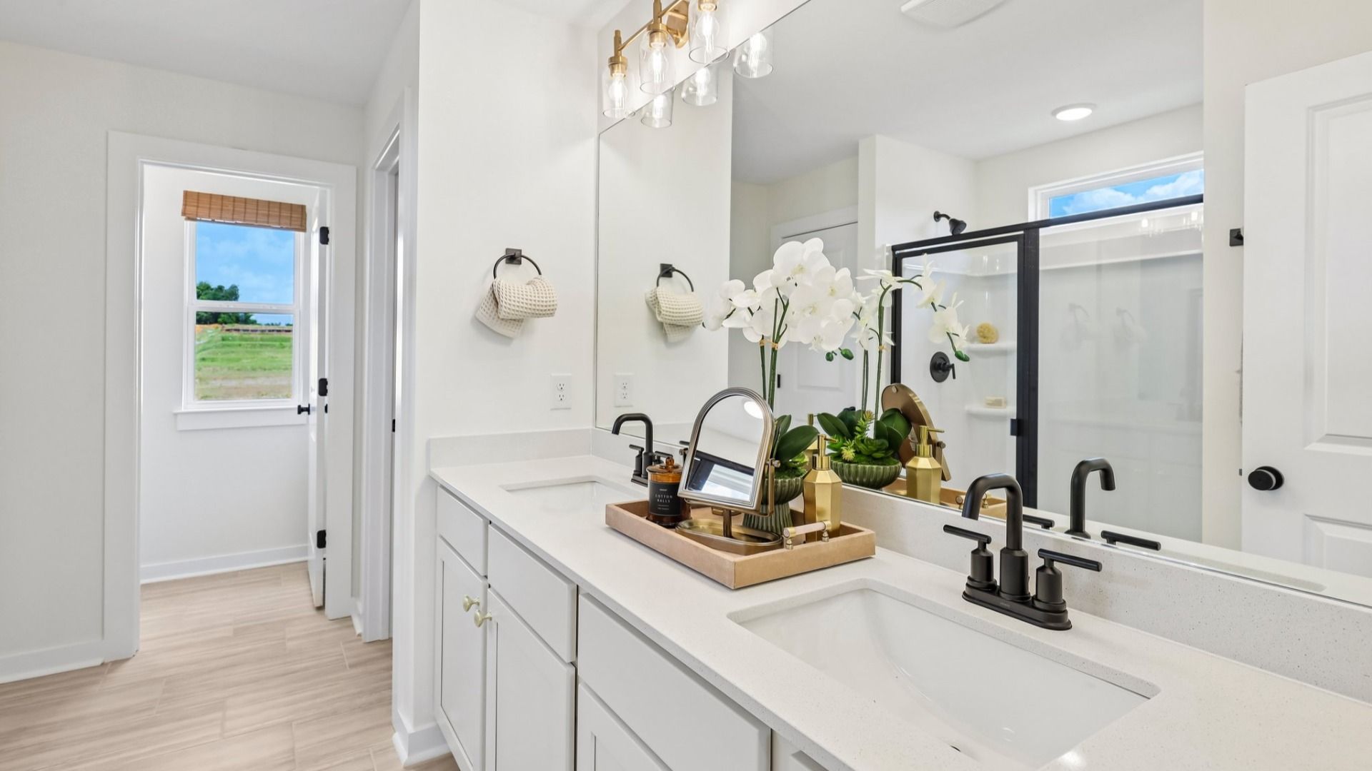 Primary bathroom with dual vanity and window