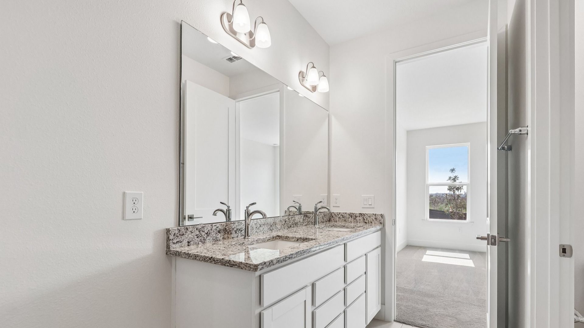 Acacia Floor Plan Primary En Suite Bathroom showcasing Dual Vanity in New Home Community Lakeside at Satilla in St. Cloud, FL