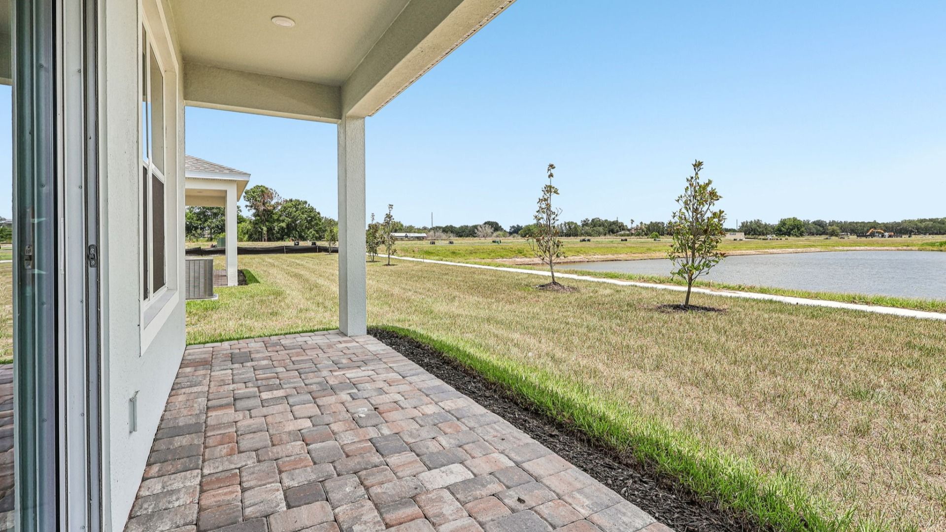 Longleaf Floor Plan Lakeside views from covered Paver rear porch by DRB Homes Lakeside at Satilla in New Homes St. Cloud