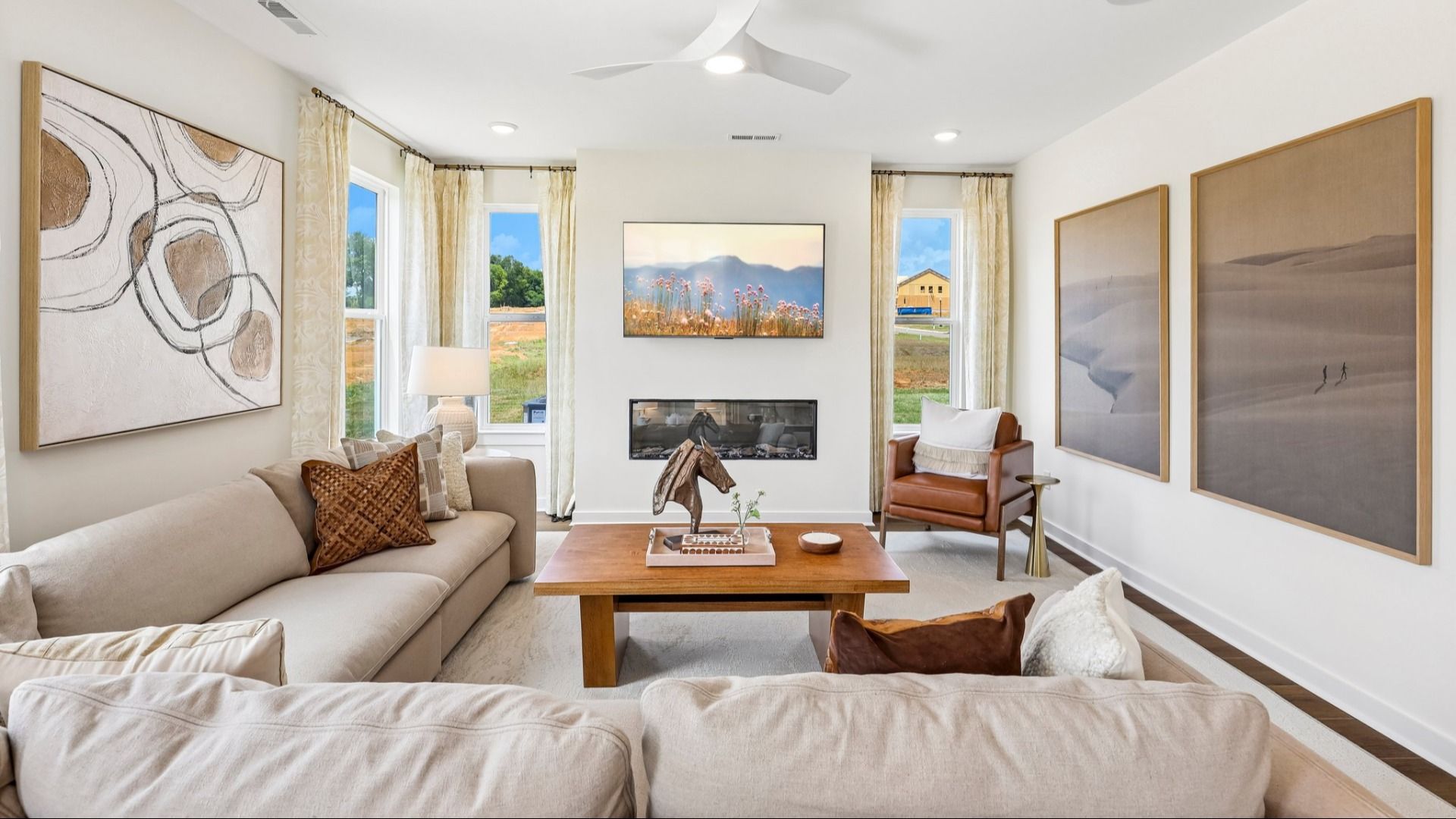 Gathering room with ceiling fan, windows, and fireplace