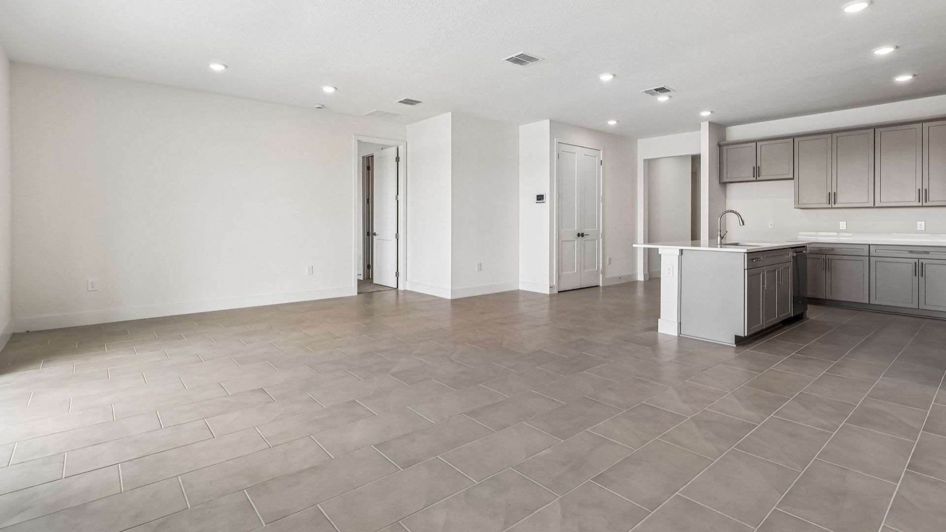 Longleaf Floor Plan Living Area and View of the Kitchen by DRB Homes in Lakeside at Satilla in New Homes St. Cloud