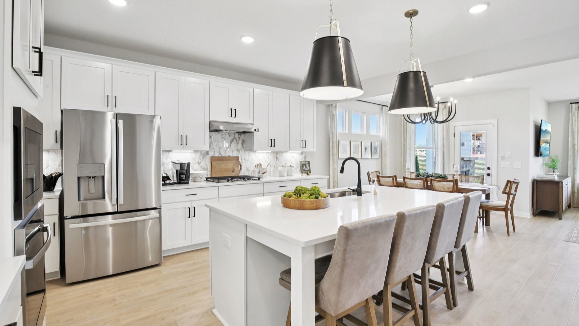 Kitchen with quartz countertops, tile backsplash, and pendant lighting