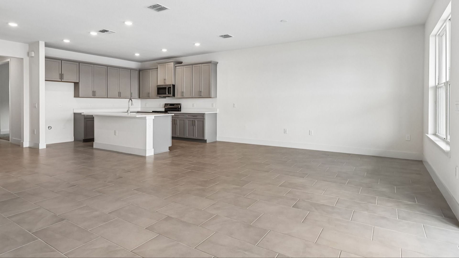 Longleaf Floor Plan Living Area and View of the Kitchen by DRB Homes in Lakeside at Satilla in New Homes St. Cloud