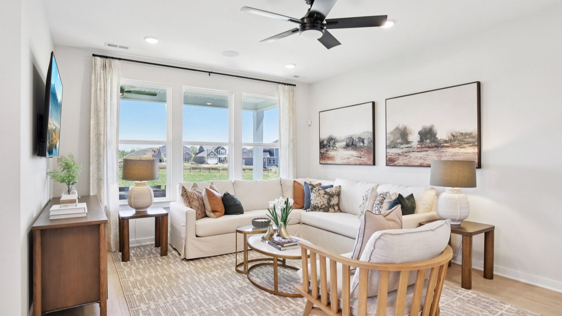 Gathering room with hard surface flooring, ceiling fan, and windows
