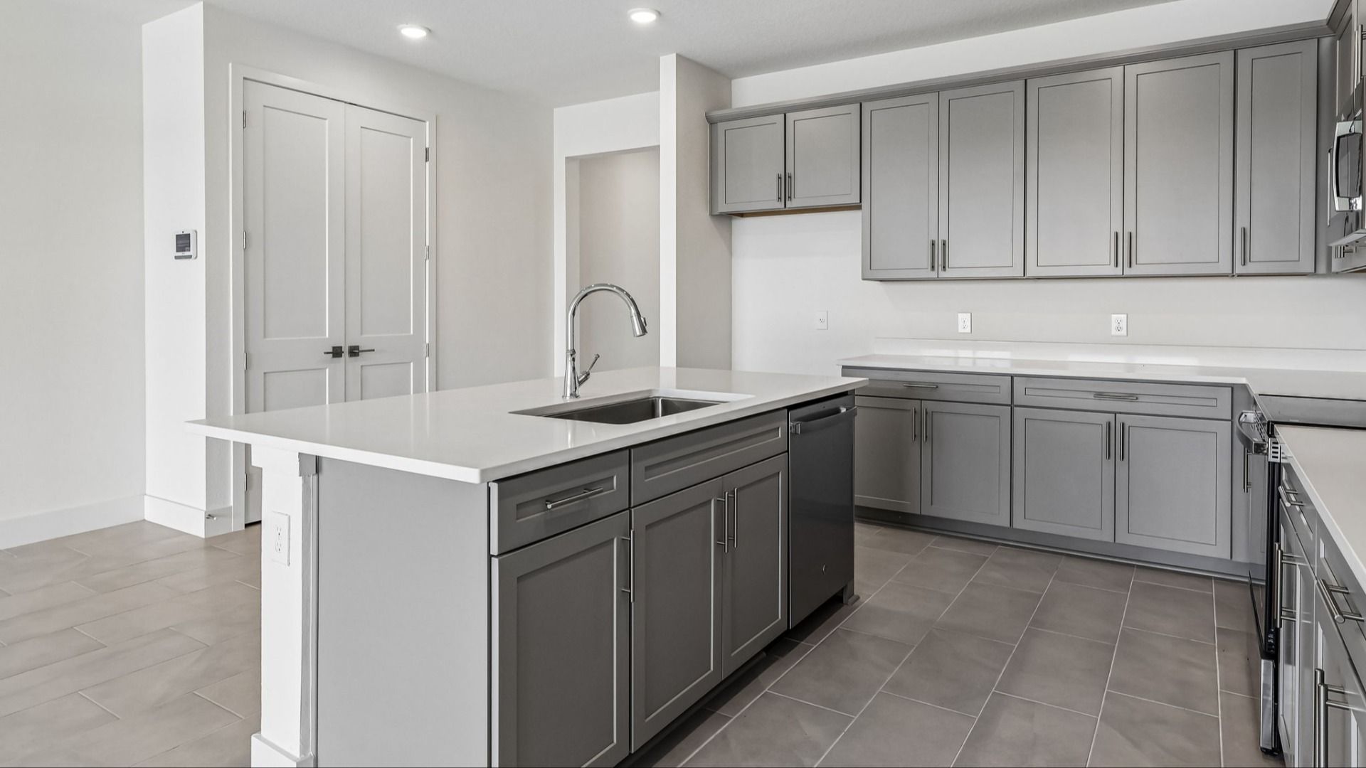 Longleaf Floor Plan Kitchen and Stunning Island by DRB Homes Lakeside at Satilla in New Homes St. Cloud