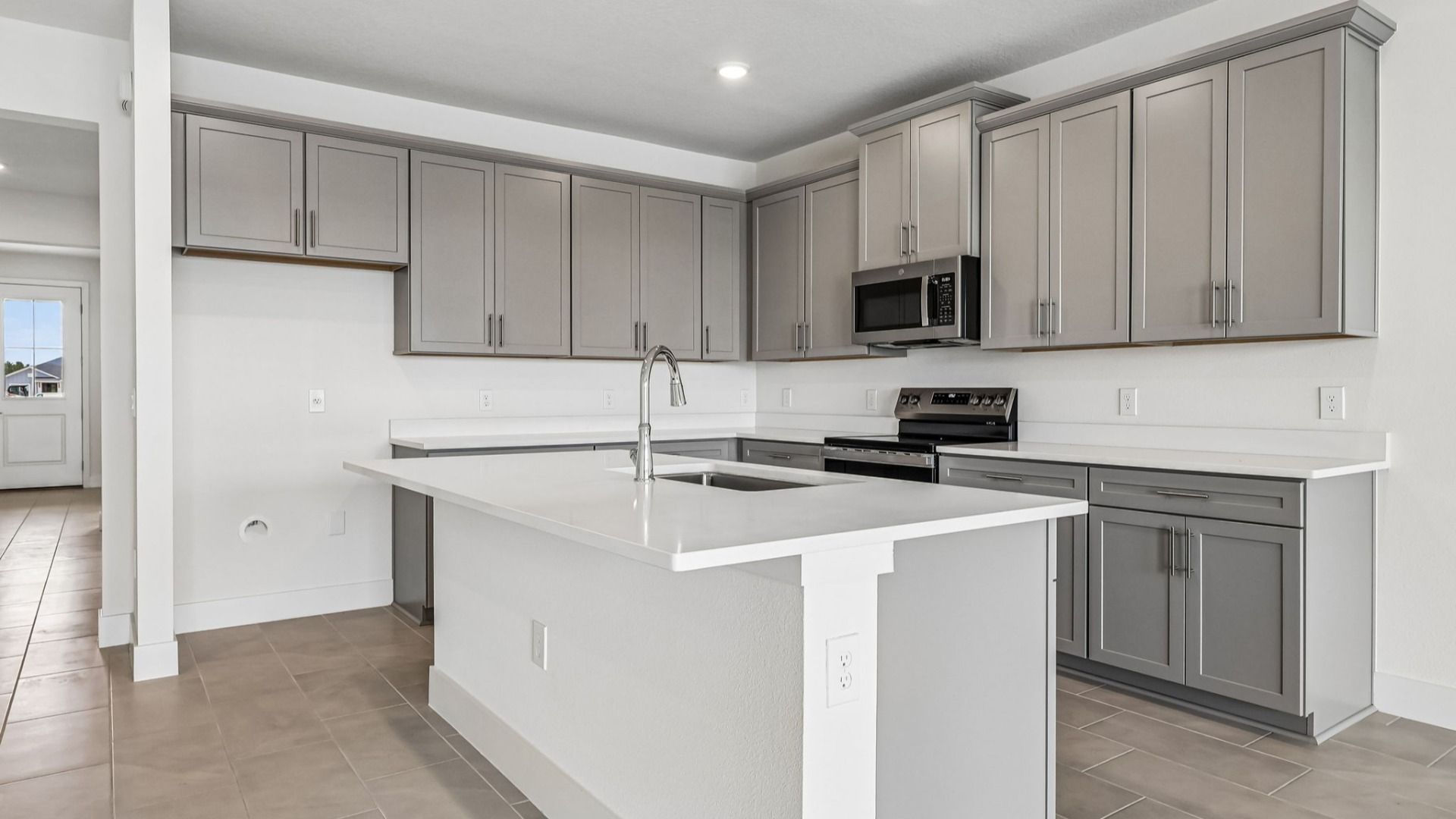 Longleaf Floor Plan Kitchen and Stunning Island by DRB Homes Lakeside at Satilla in New Homes St. Cloud