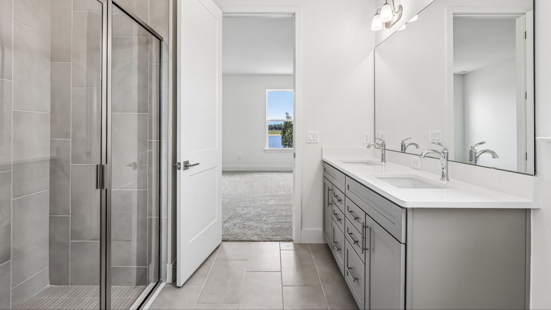 Longleaf Floor Plan Primary Suite Bath with Floor to Ceiling Tile and Glass Encased Shower