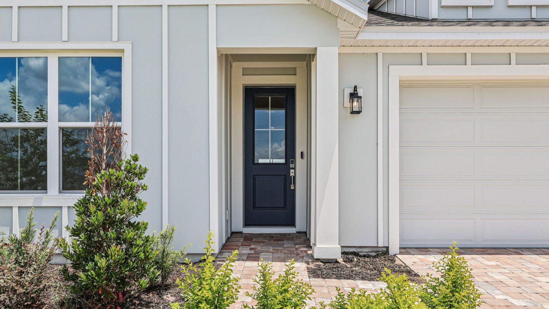 Longleaf Floor Plan Exterior with Paver Driveway and Walkway New Homes in St. Cloud at Lakeside at Satilla