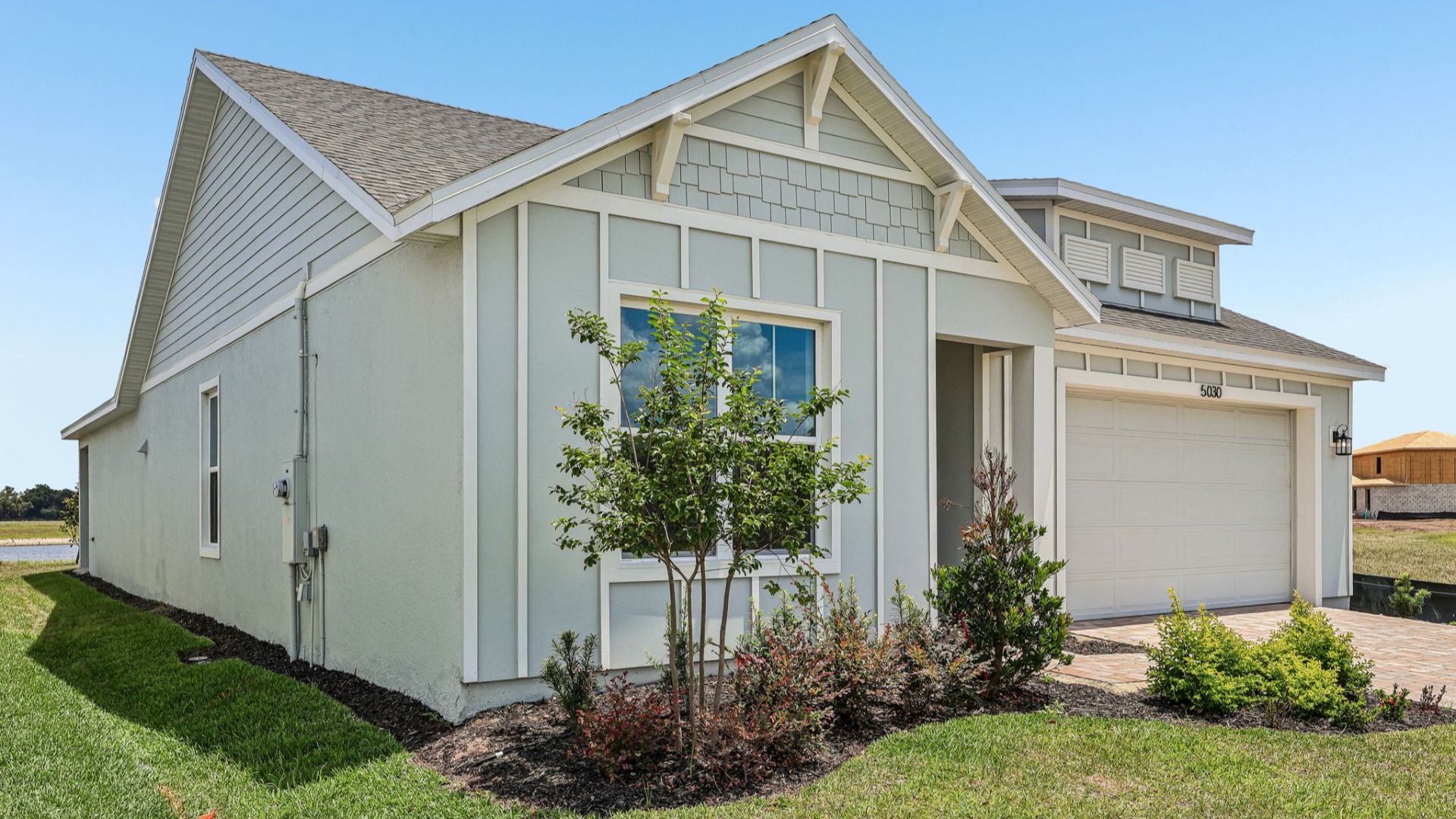 Longleaf Floor Plan Exterior with Paver Driveway and Walkway New Homes in St. Cloud at Lakeside at Satilla
