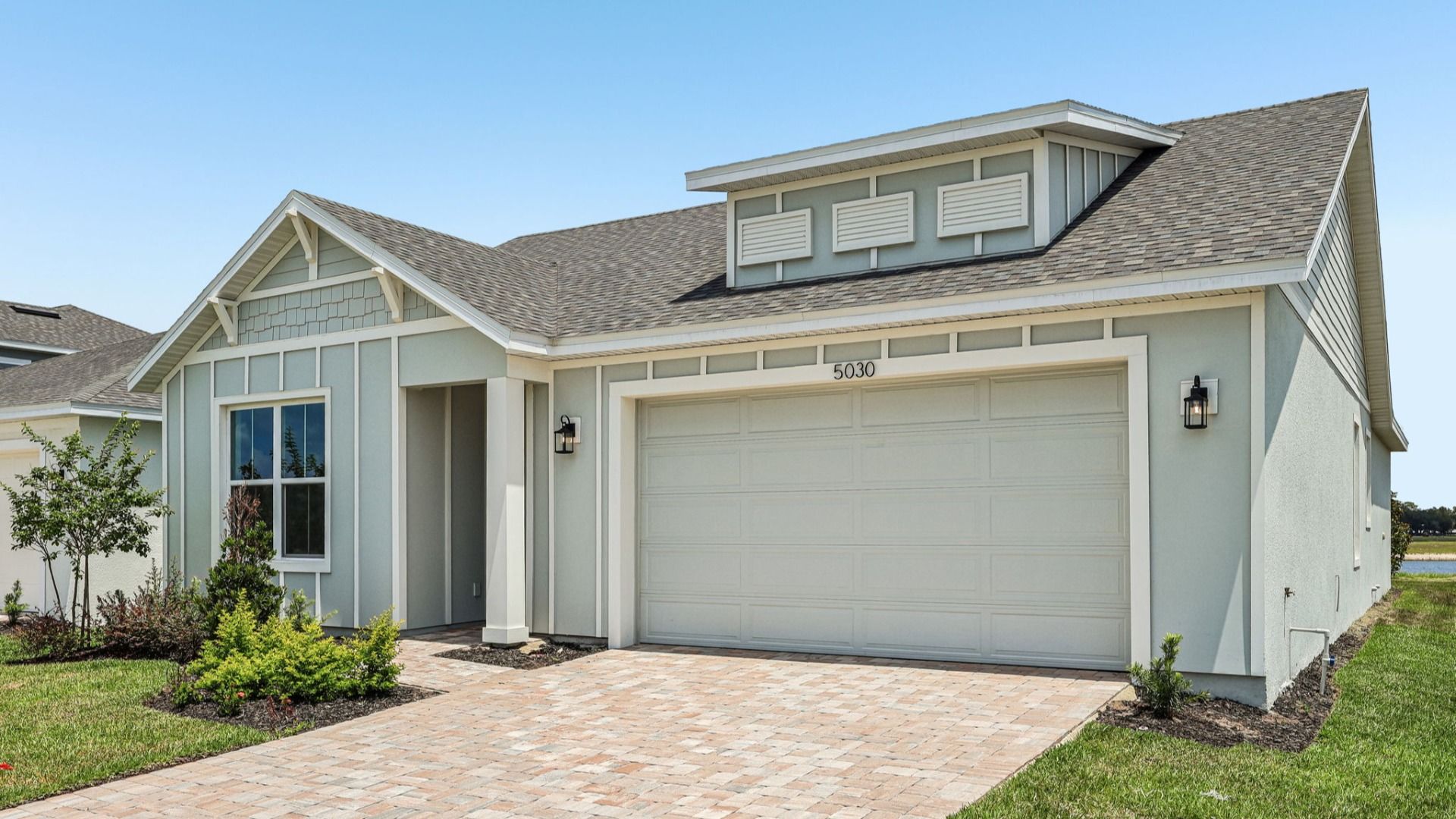 Longleaf Floor Plan Exterior with Paver Driveway and Walkway New Homes in St. Cloud at Lakeside at Satilla
