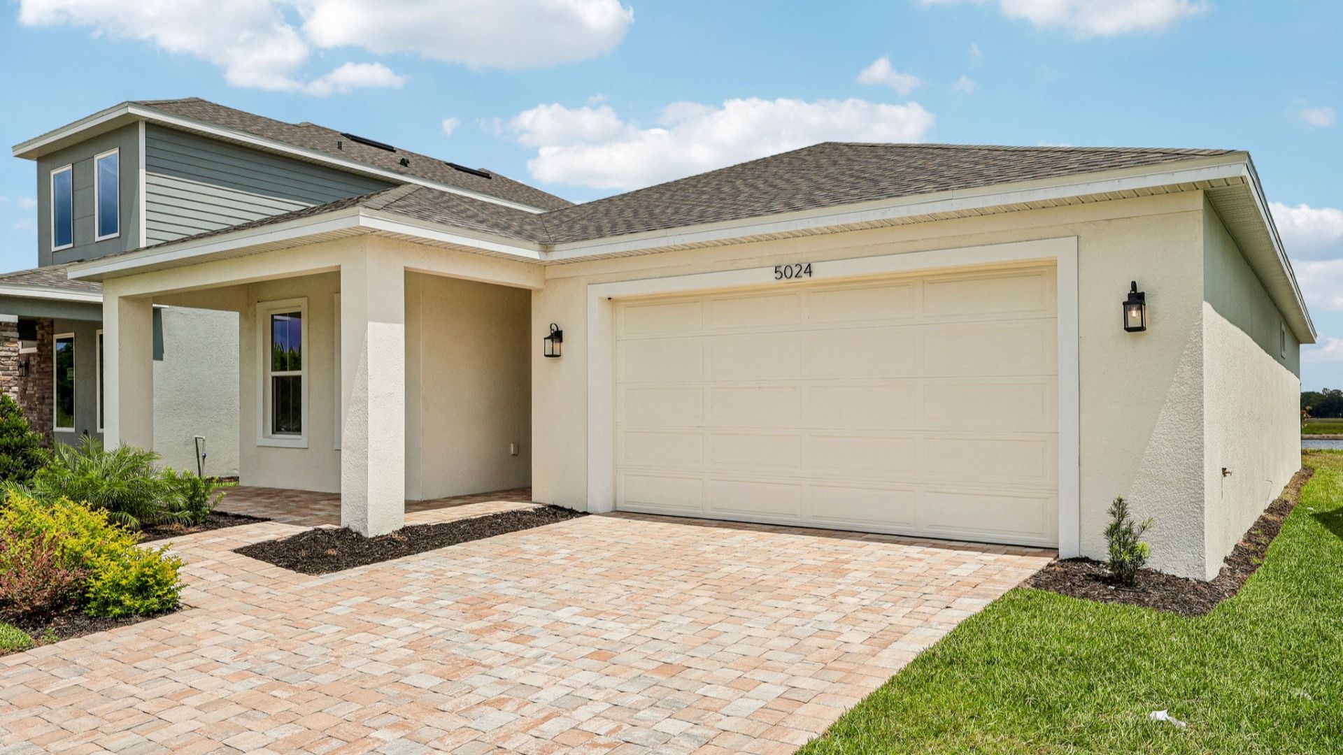 Buttonwood Floor Plan Exterior with a Paver Driveway by DRB Homes in Lakeside at Satilla in St. Cloud, FL