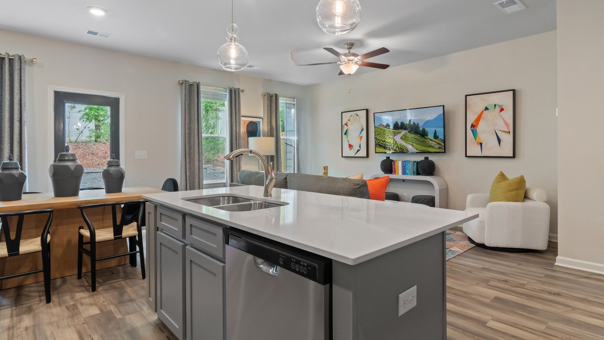 Decorated kitchen island with nearby dining area and gathering room