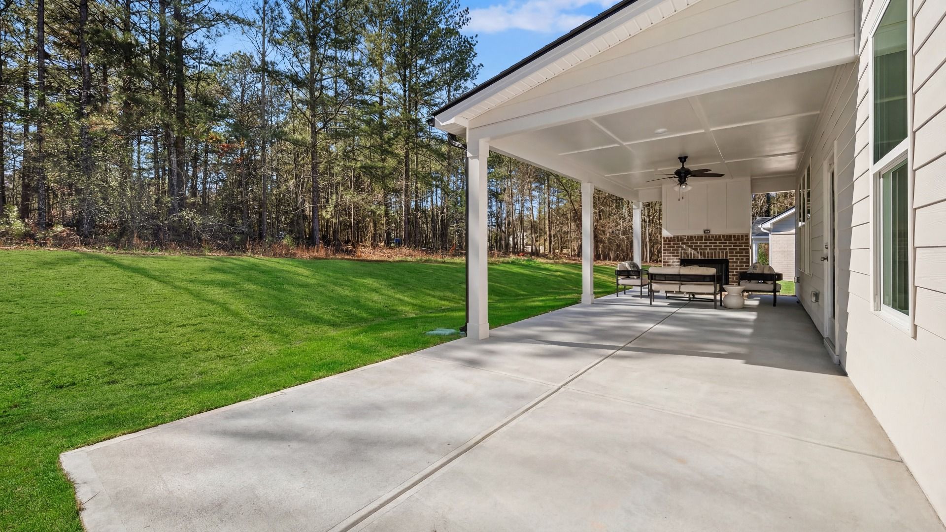 Spacious covered rear porch with fireplace