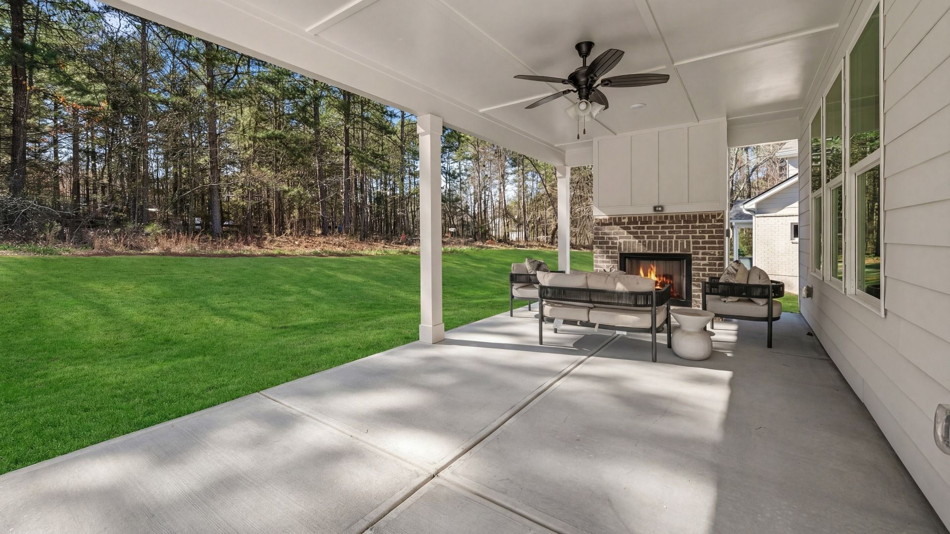 Spacious covered rear porch with fireplace