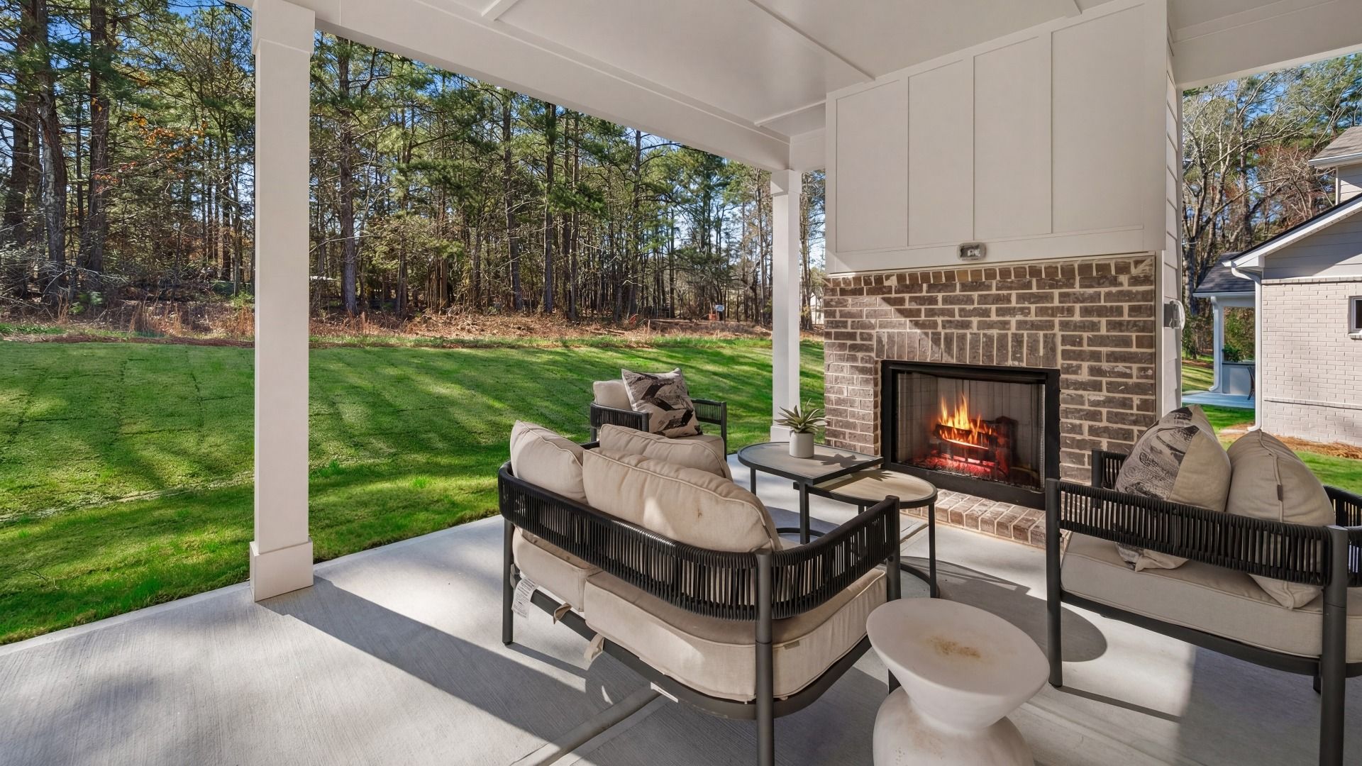 Spacious covered rear porch with fireplace