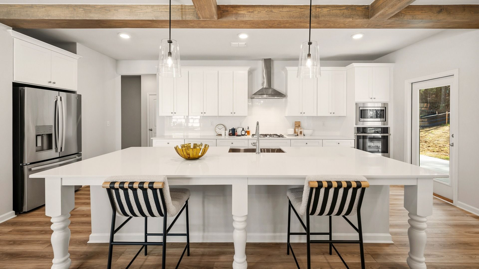 Kitchen with tile backsplash, quartz countertops, and pendant lighting