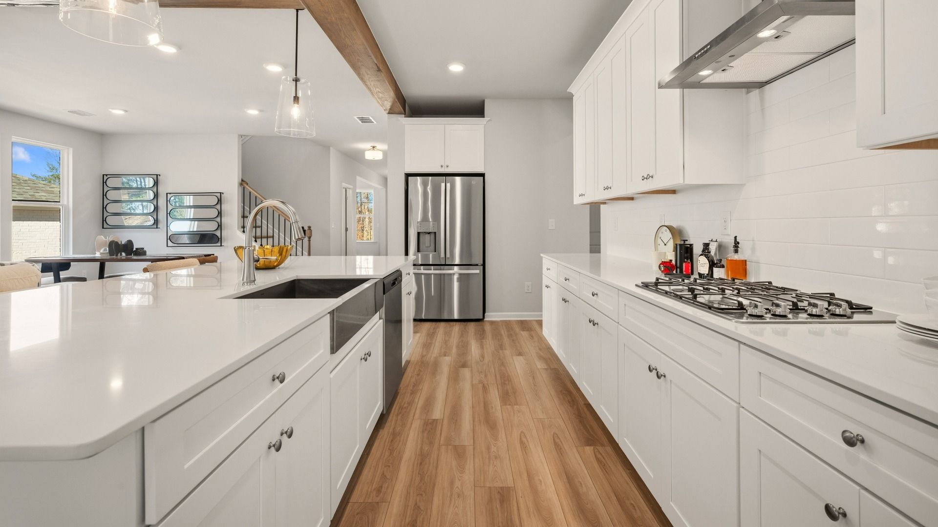 Kitchen with tile backsplash, quartz countertops, and pendant lighting