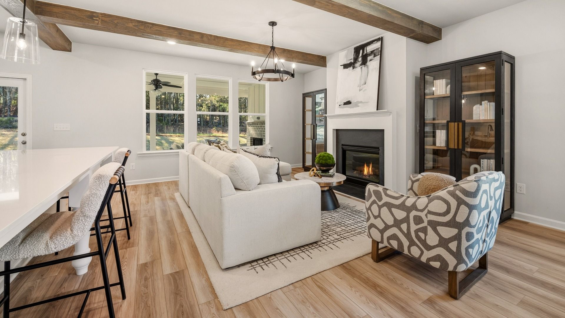 Gathering room with accent ceiling, fireplace, and windows