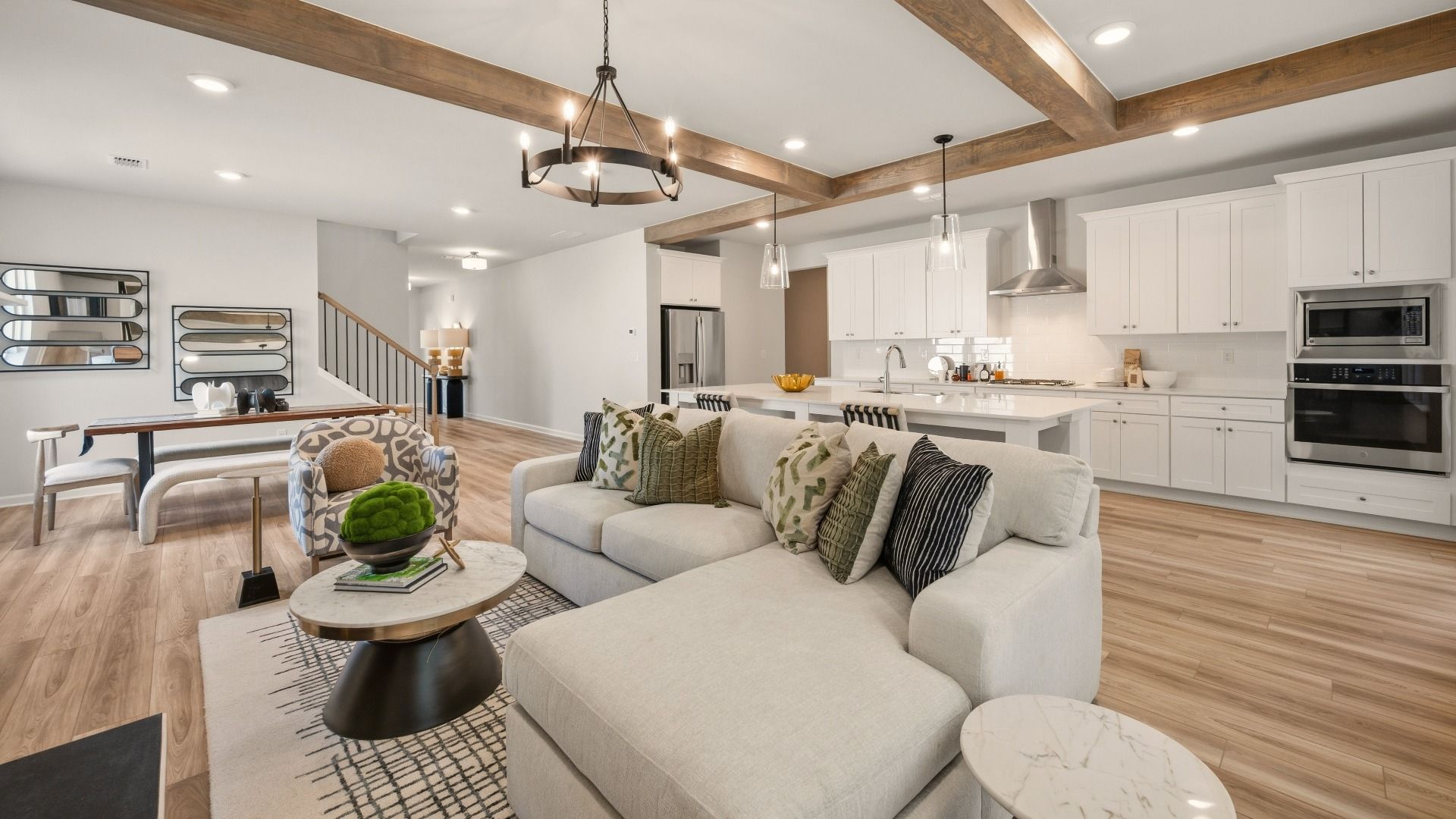 Gathering room with accent ceiling and view of kitchen and dining areas
