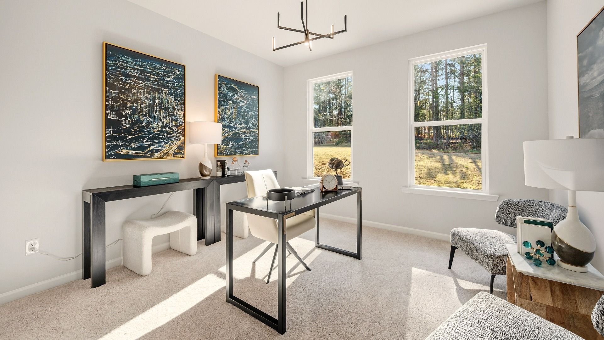 Bedroom with bright natural lighting from windows and carpet, used as an office