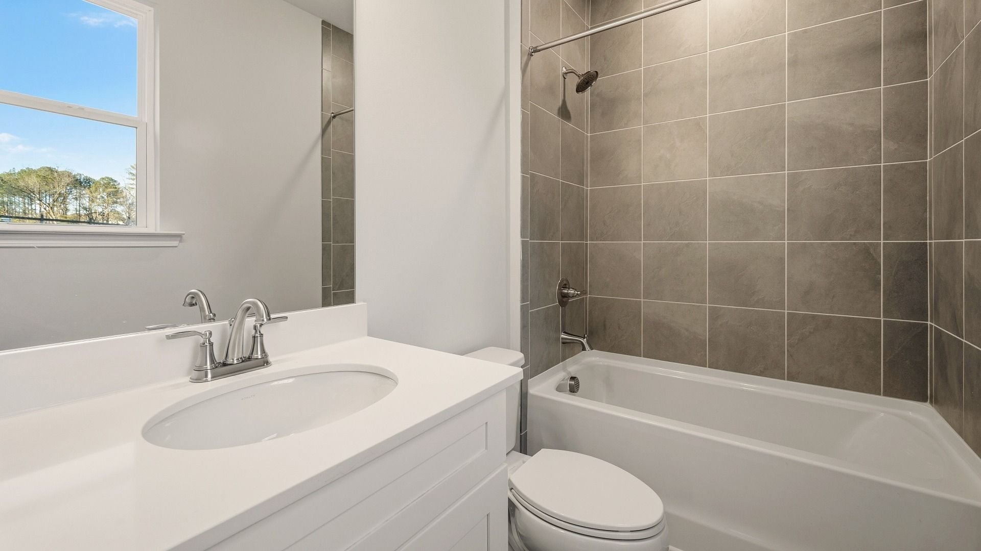 Secondary bathroom with single vanity and tiled shower