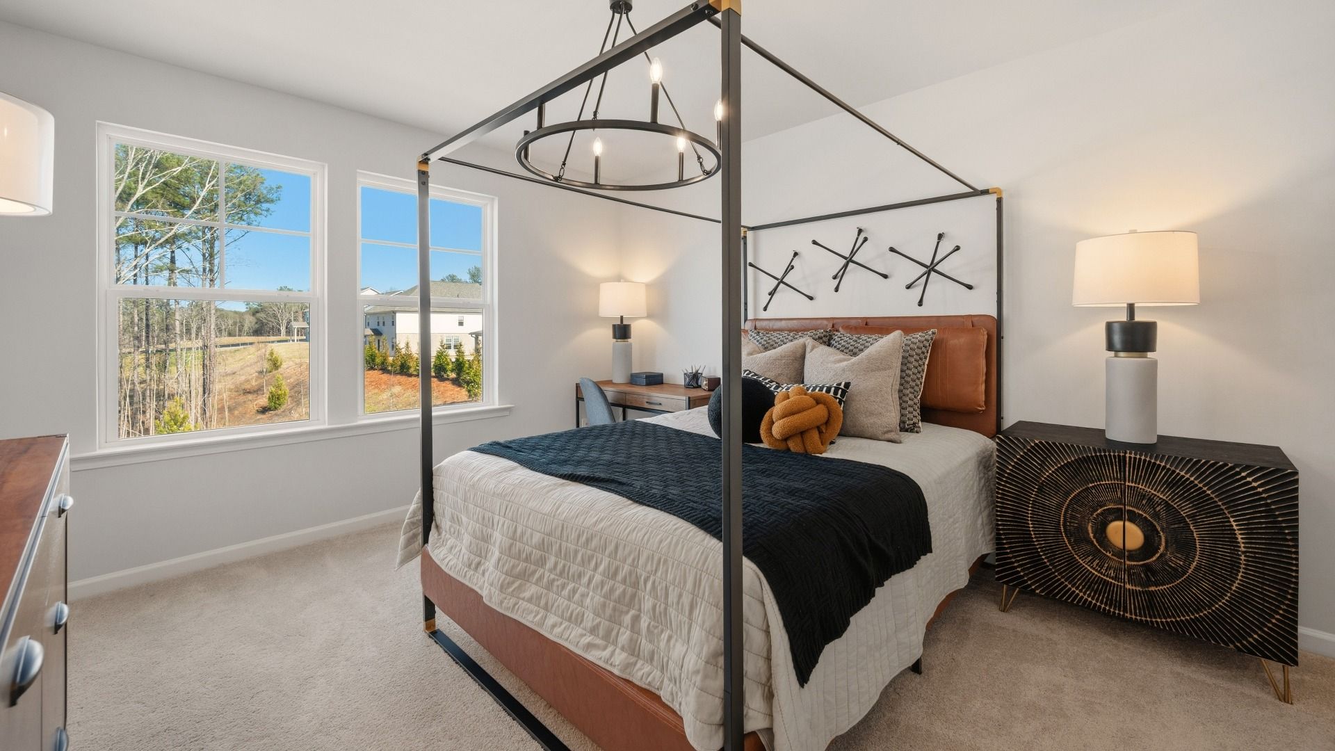 Bedroom with bright natural lighting from windows and carpet