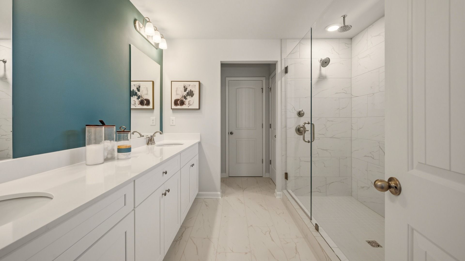 Primary bathroom with dual vanity and spacious glass enclosed shower with shower window