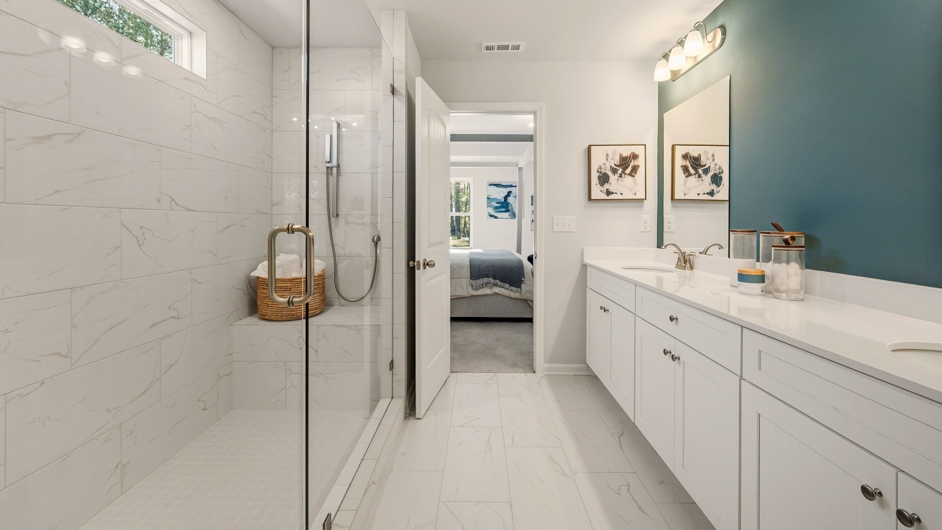 Primary bathroom with dual vanity and spacious glass enclosed shower with shower window