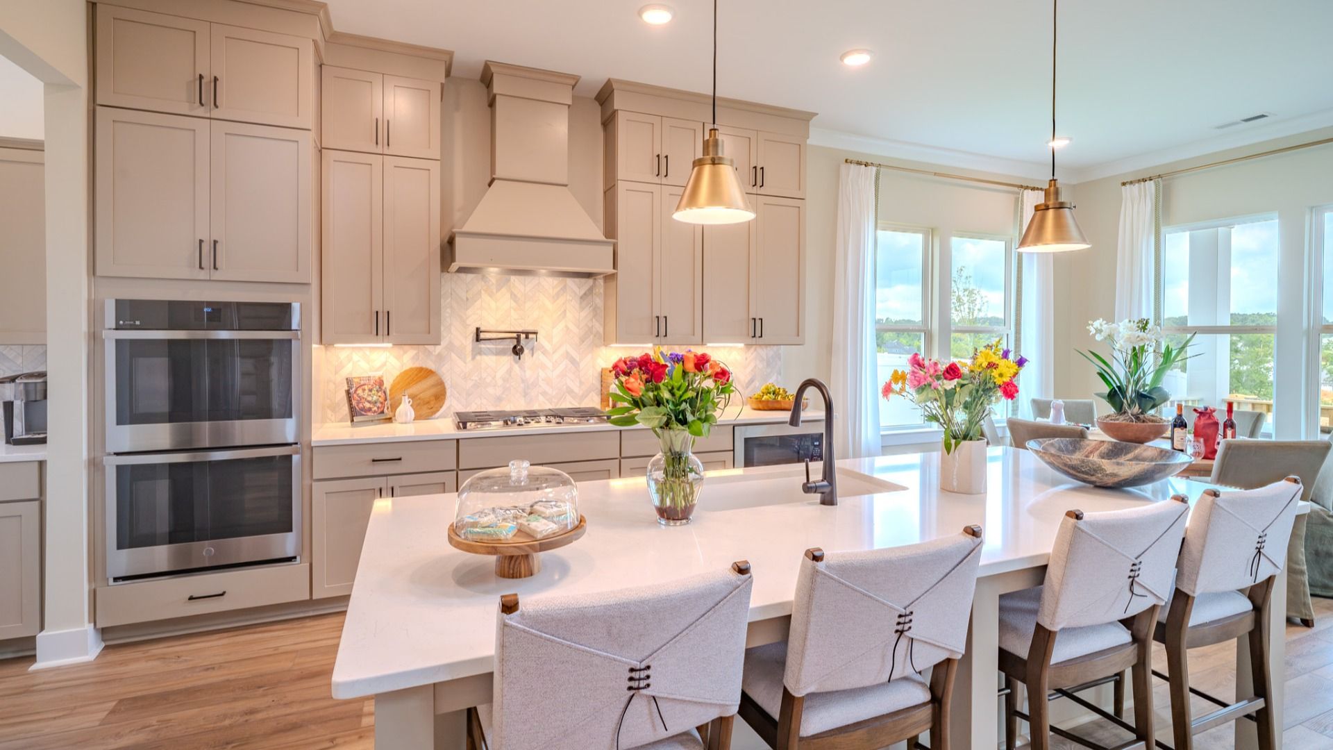 Kitchen with tile backsplash, quartz countertops, and pendant lighting