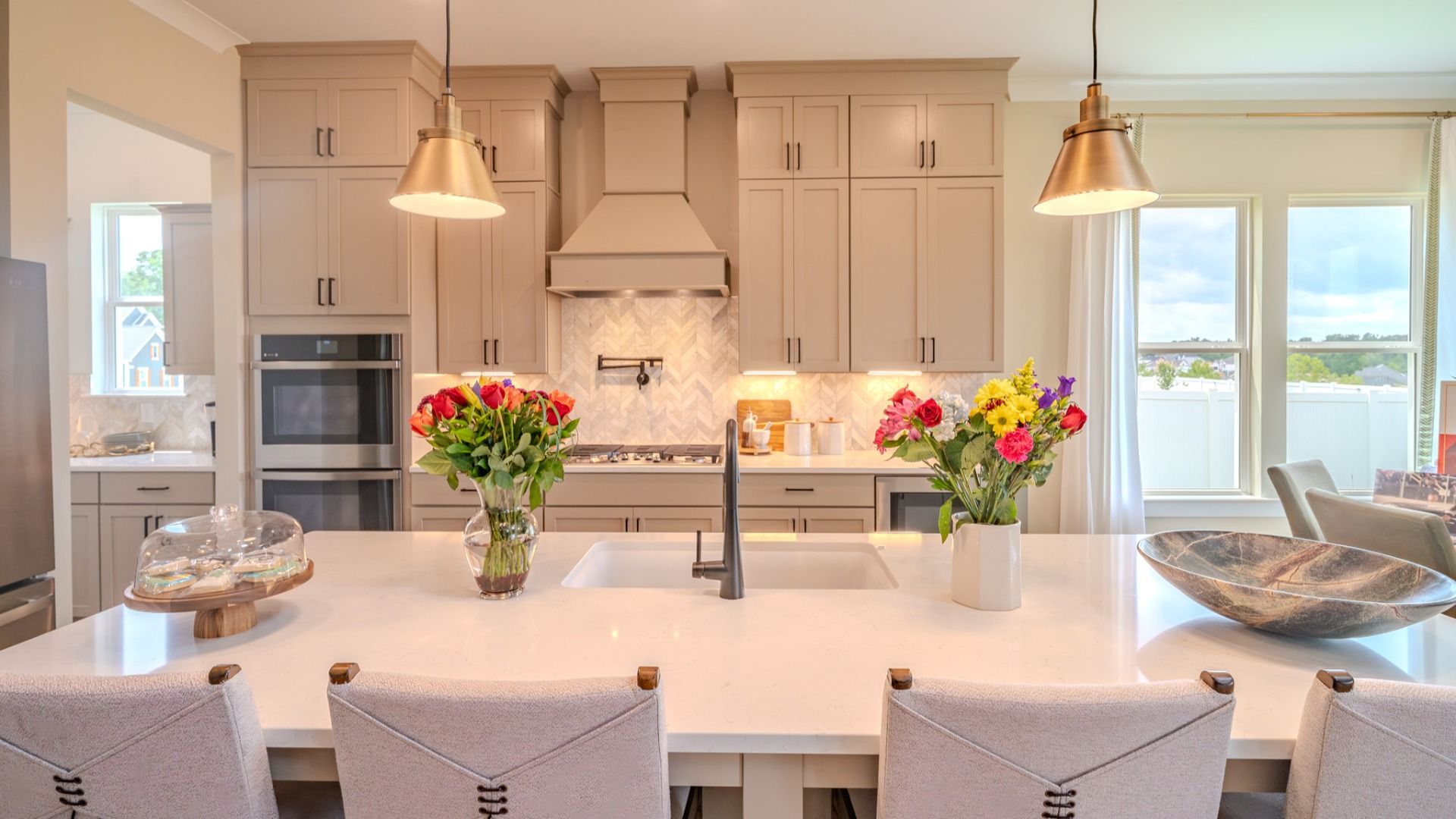 Kitchen with tile backsplash, quartz countertops, and pendant lighting