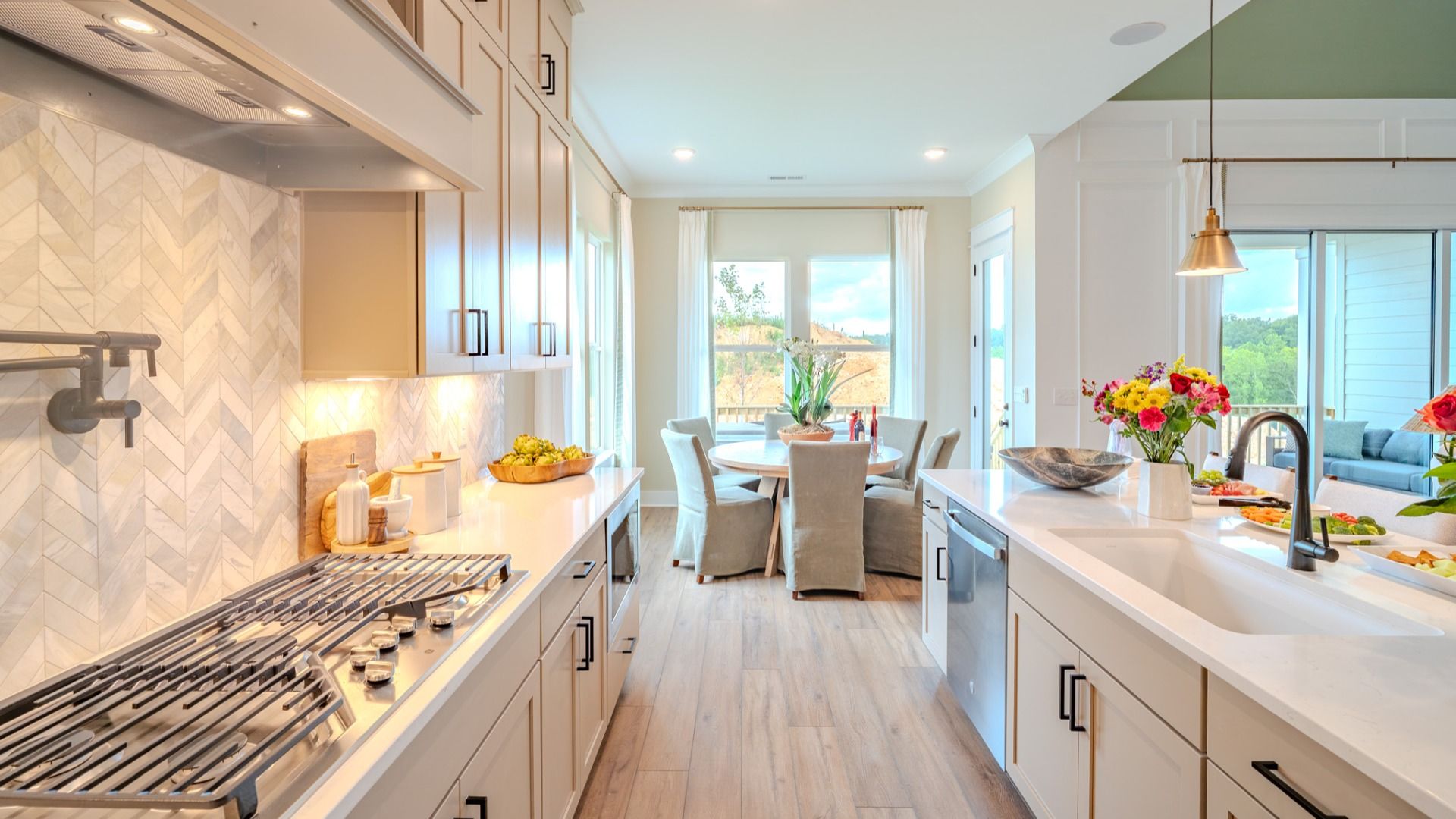 Kitchen with tile backsplash, quartz countertops, and pendant lighting