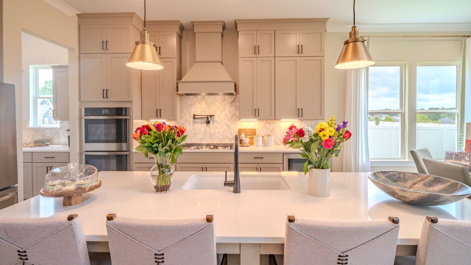 Kitchen with tile backsplash, quartz countertops, and pendant lighting