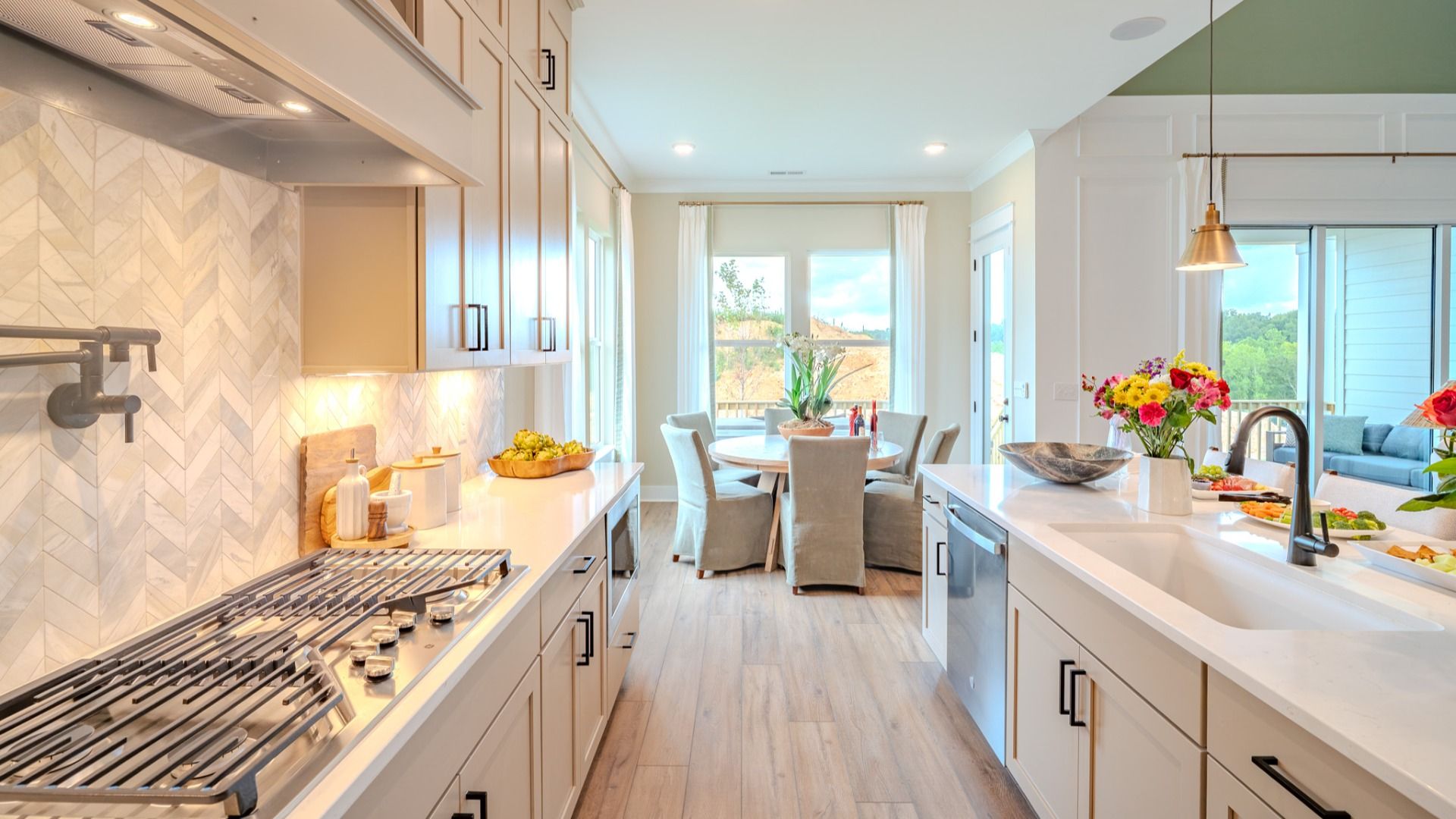 Kitchen with tile backsplash, quartz countertops, and pendant lighting