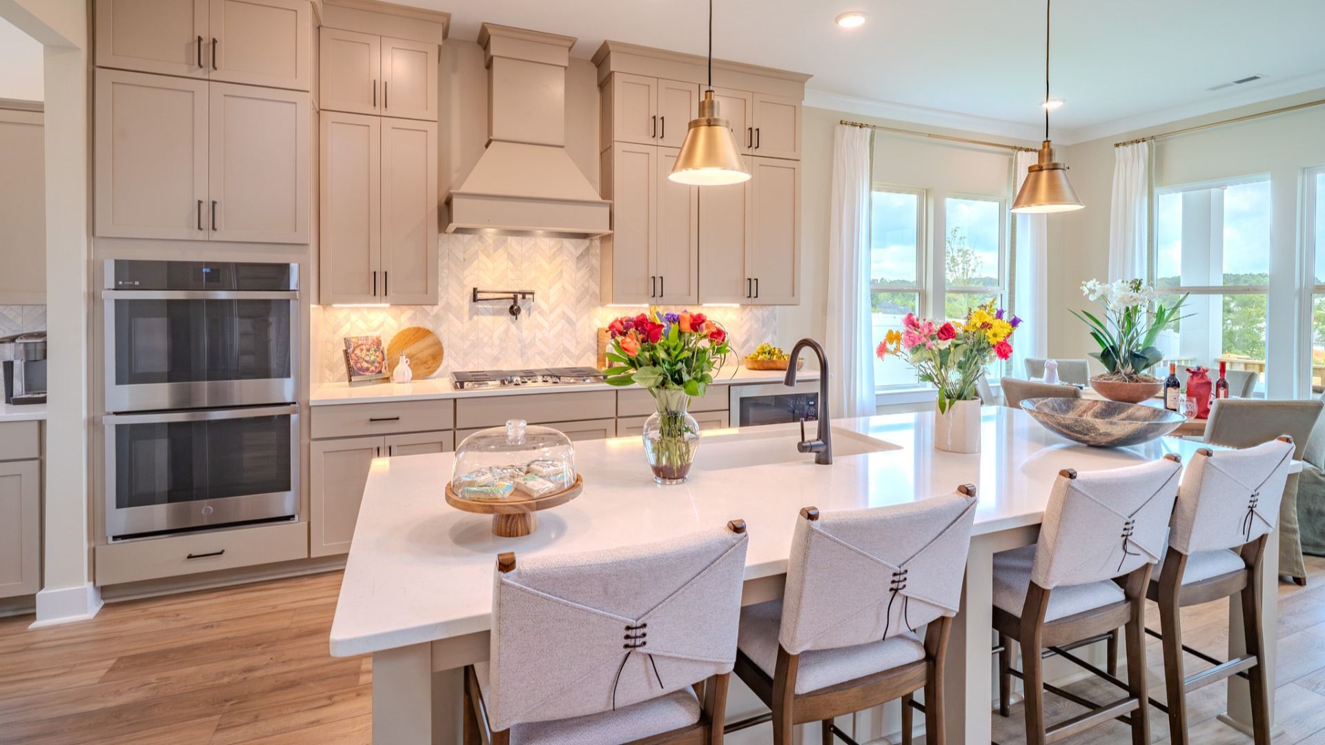 Kitchen with tile backsplash, quartz countertops, and pendant lighting
