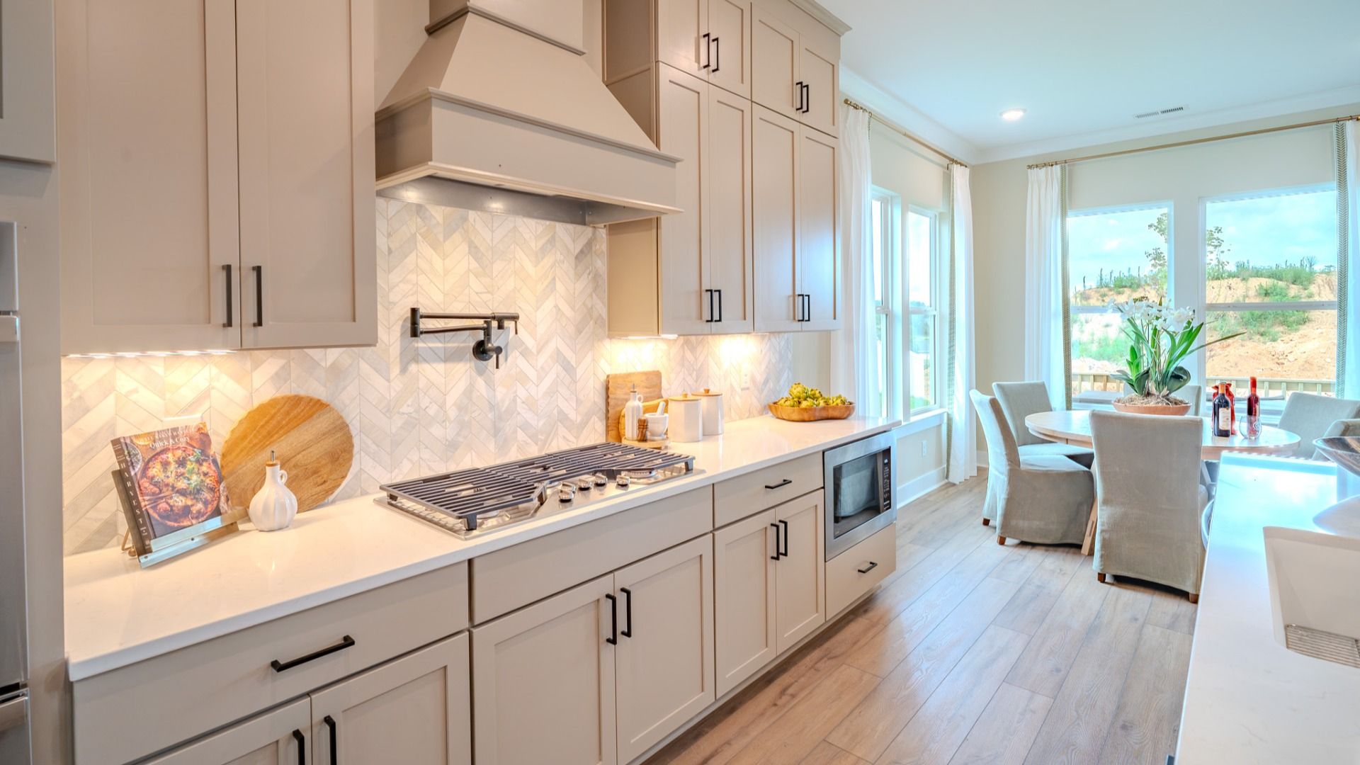 Kitchen with tile backsplash, quartz countertops, and pendant lighting