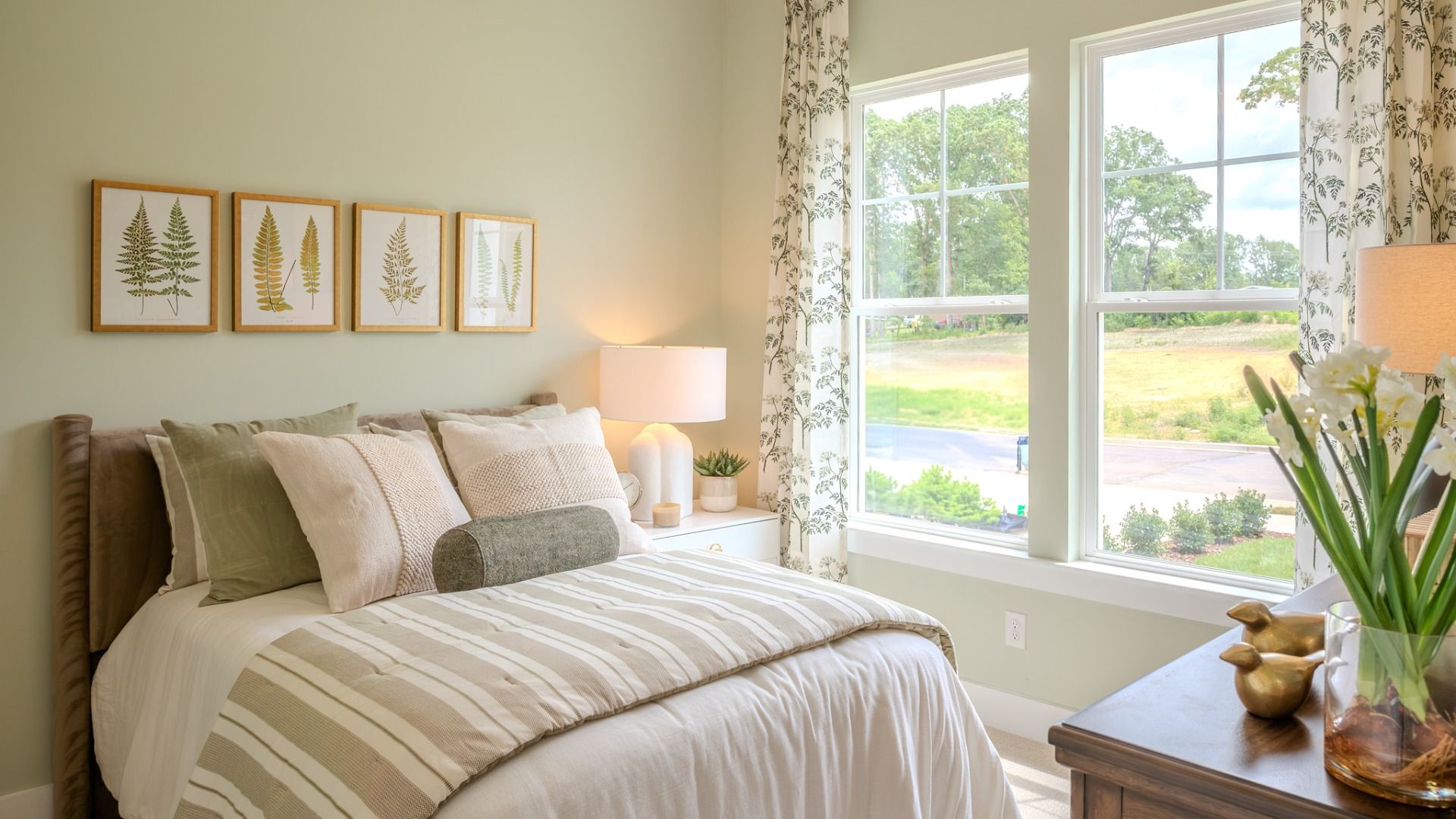 Secondary bedroom with carpet and bright natural light from windows