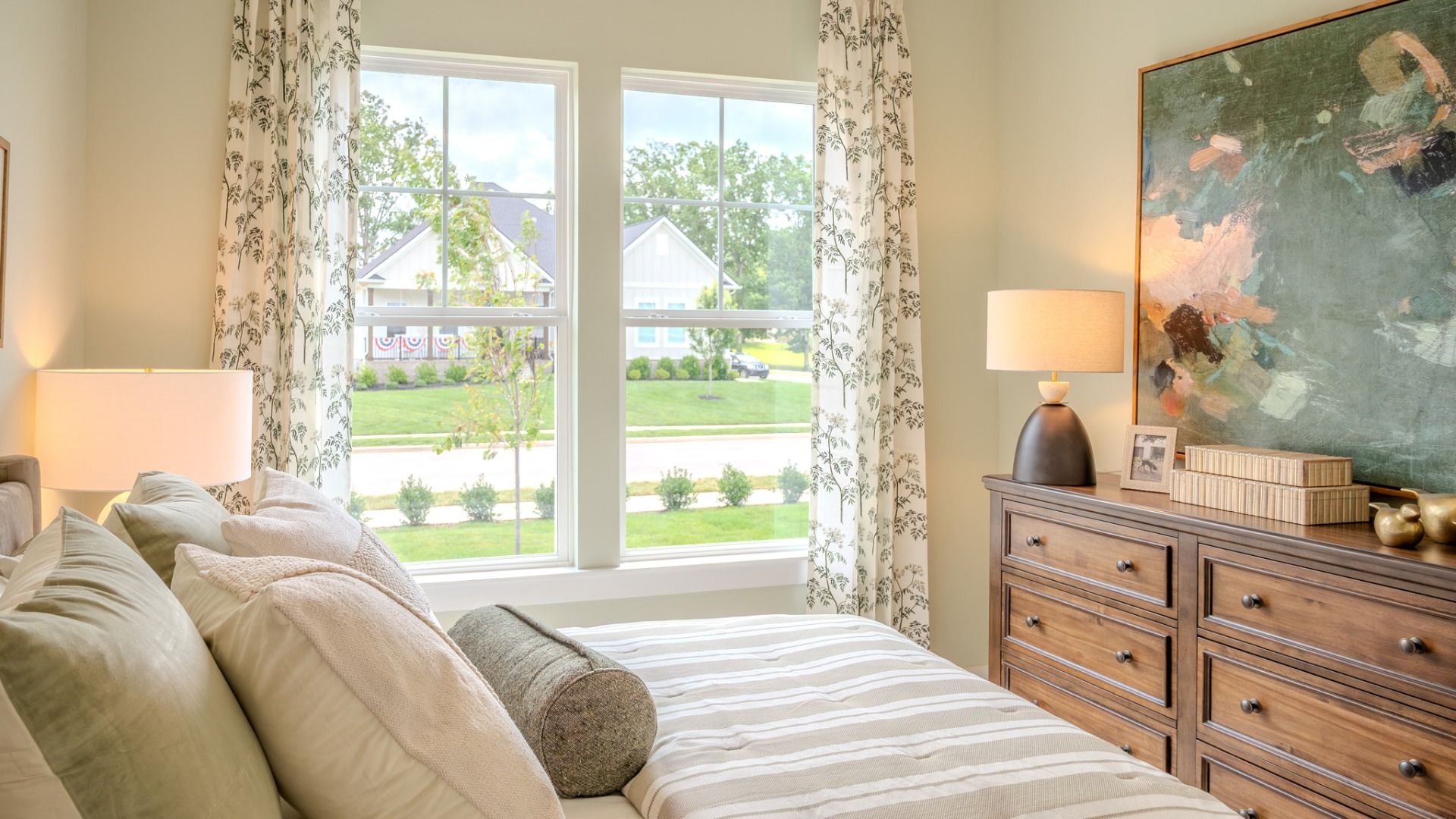 Secondary bedroom with carpet and bright natural light from windows